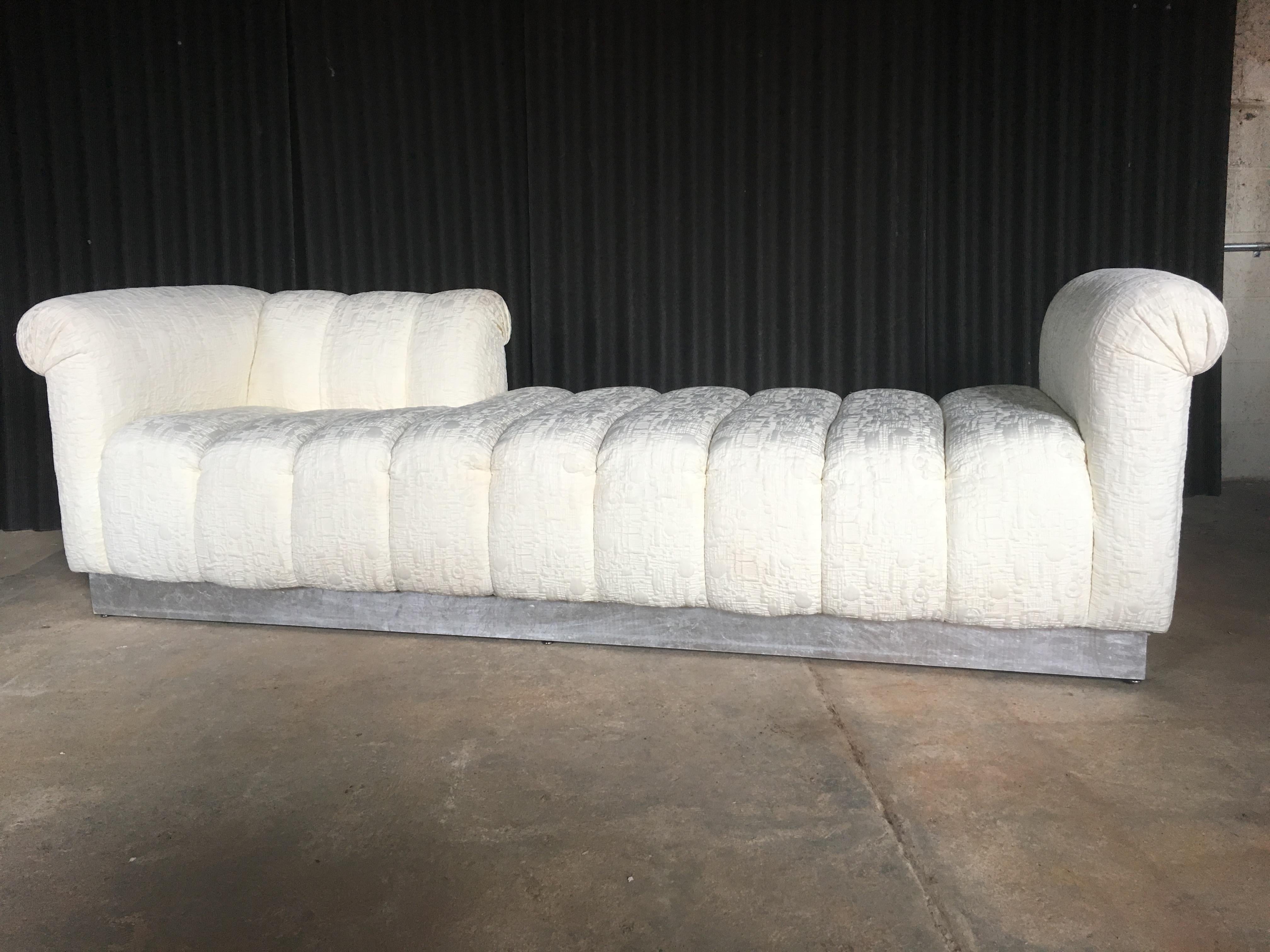 One of the most fantastic chaise Lounges that you'll ever run across.
Ivory, richly texted fabric, is in fantastic condition with no rips tears or stains.
Plinth base is wood and is silver leafed, not chrome. Tag underneath reads: Silver Leaf.
One