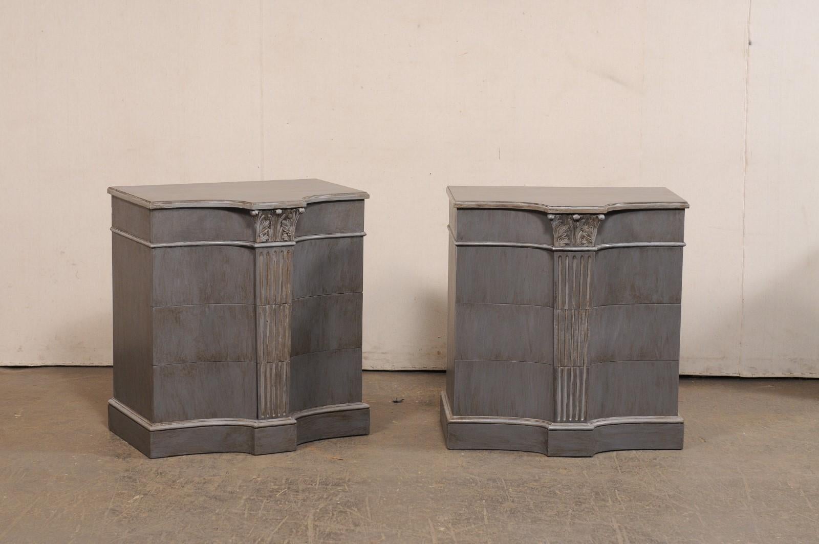 A very cool pair of French carved and painted wood side chests, with central fluted column motif, from the mid 20th century. This pair of commodes from France each feature a clean design with emphasis on a fluted column with ionic capitals at the
