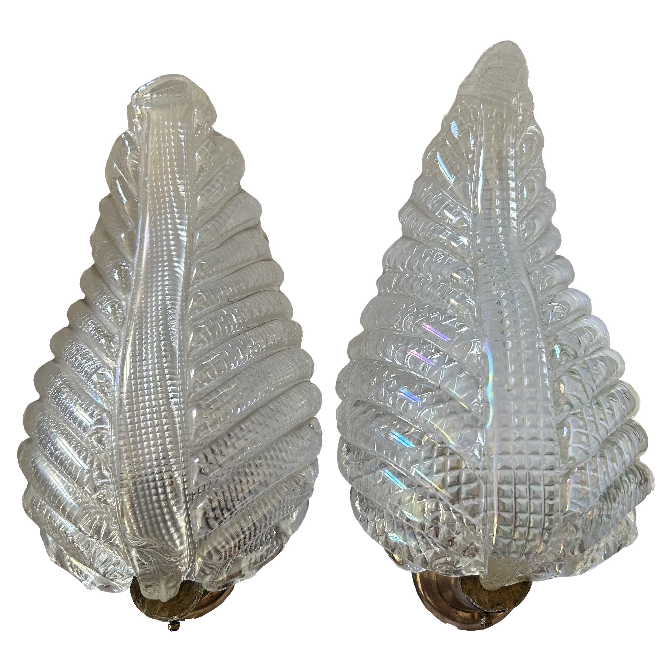 Magnificent pair of original 1940's Murano sconces, made of the finest and heavy iridescent glass. Brass structure. Authentic jewels of eternal beauty. The indicated measures refer to the slightly smaller piece. The dimensions of the other piece are