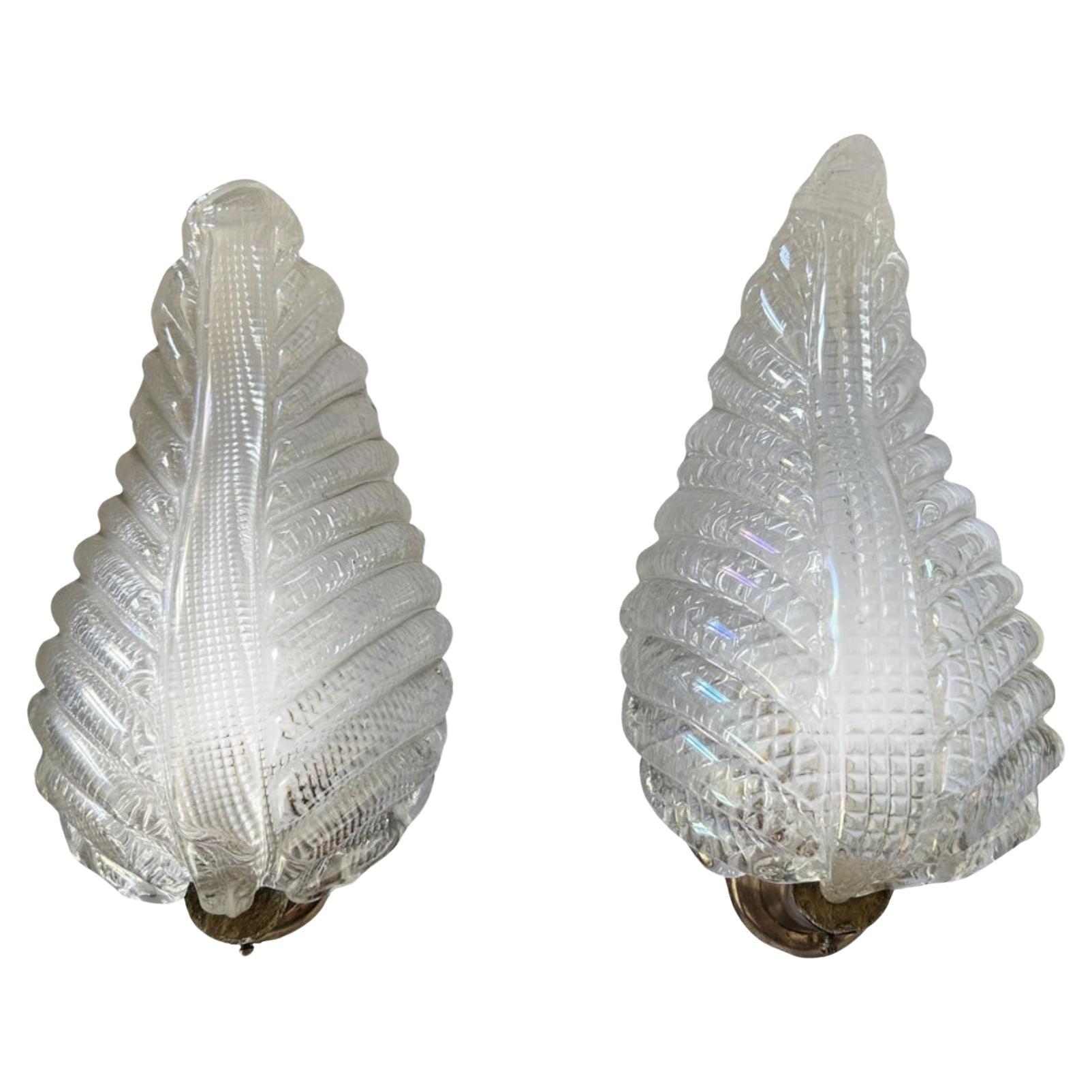 Magnificent pair of original 1940's Murano sconces, made of the finest and heavy iridescent glass. Brass structure. Authentic jewels of eternal beauty. The indicated measures refer to the slightly smaller piece. The dimensions of the other piece are