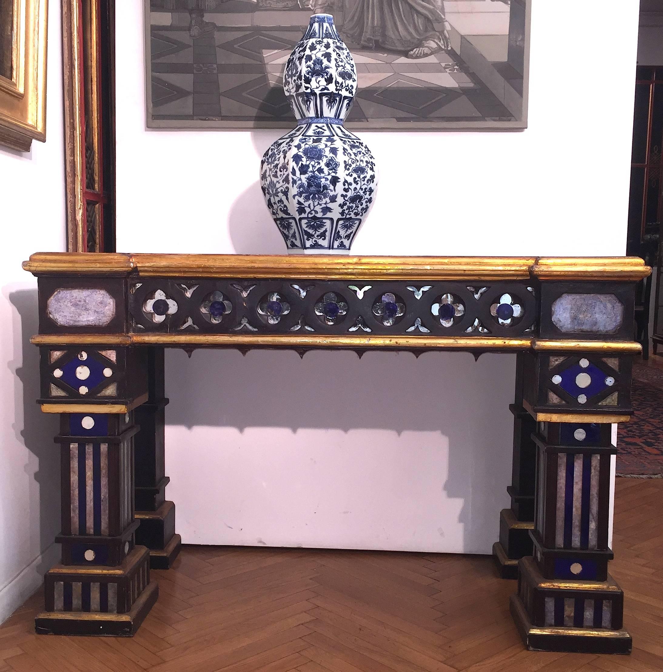 A pair of high curiosity Neo-Gothic console tables of architectural form.
Ebony painted wood with painted glass insert and painted imitation marble top.
Sicily, 19th century.
Measures: Cm 141 x 61 x 90 H.
 