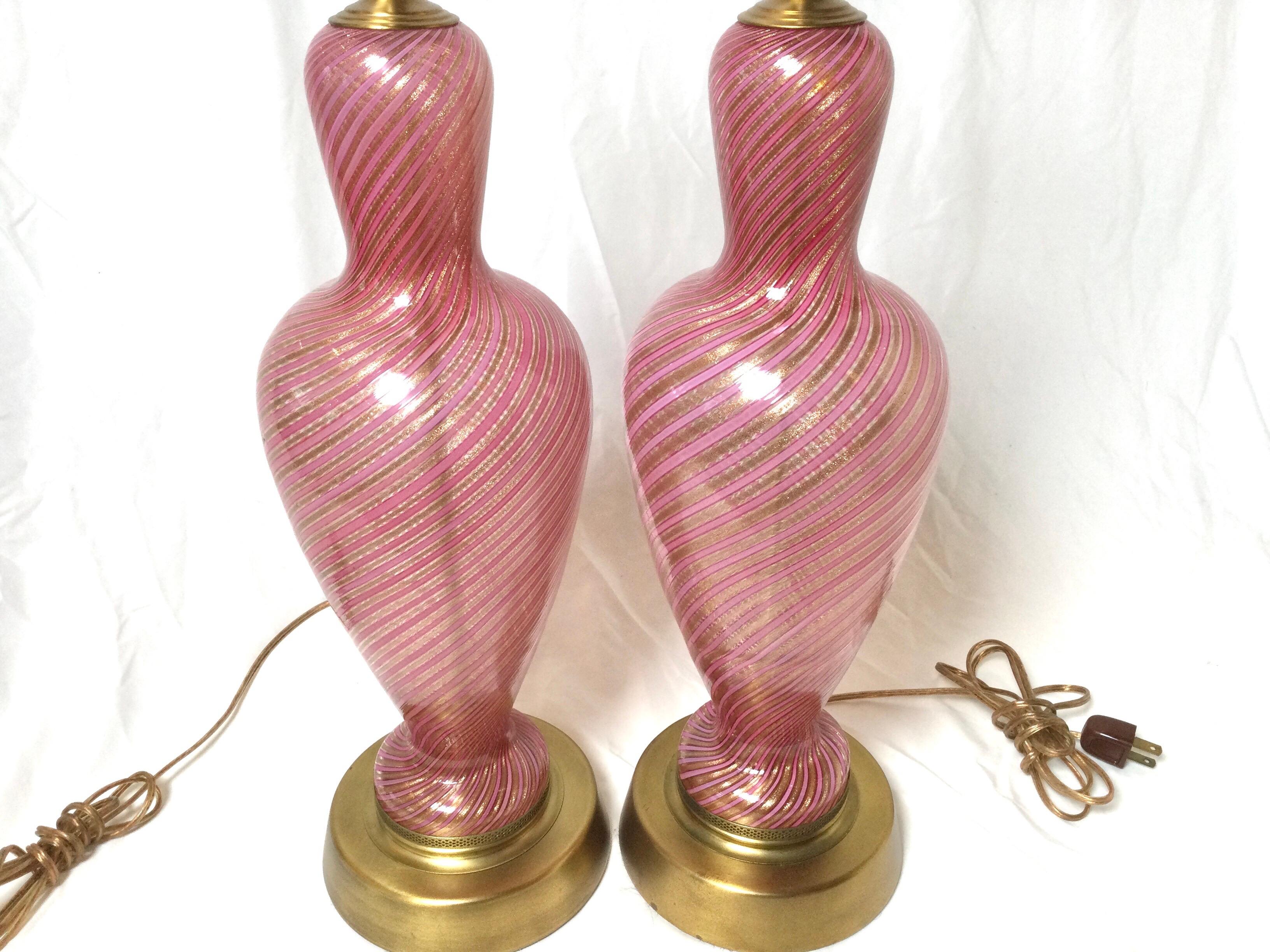 Elegant pair of hand blown Italian Murano glass lamps. The pink and transparent swirled glass on gold toned metal bases. Height to top of a shade would be 31