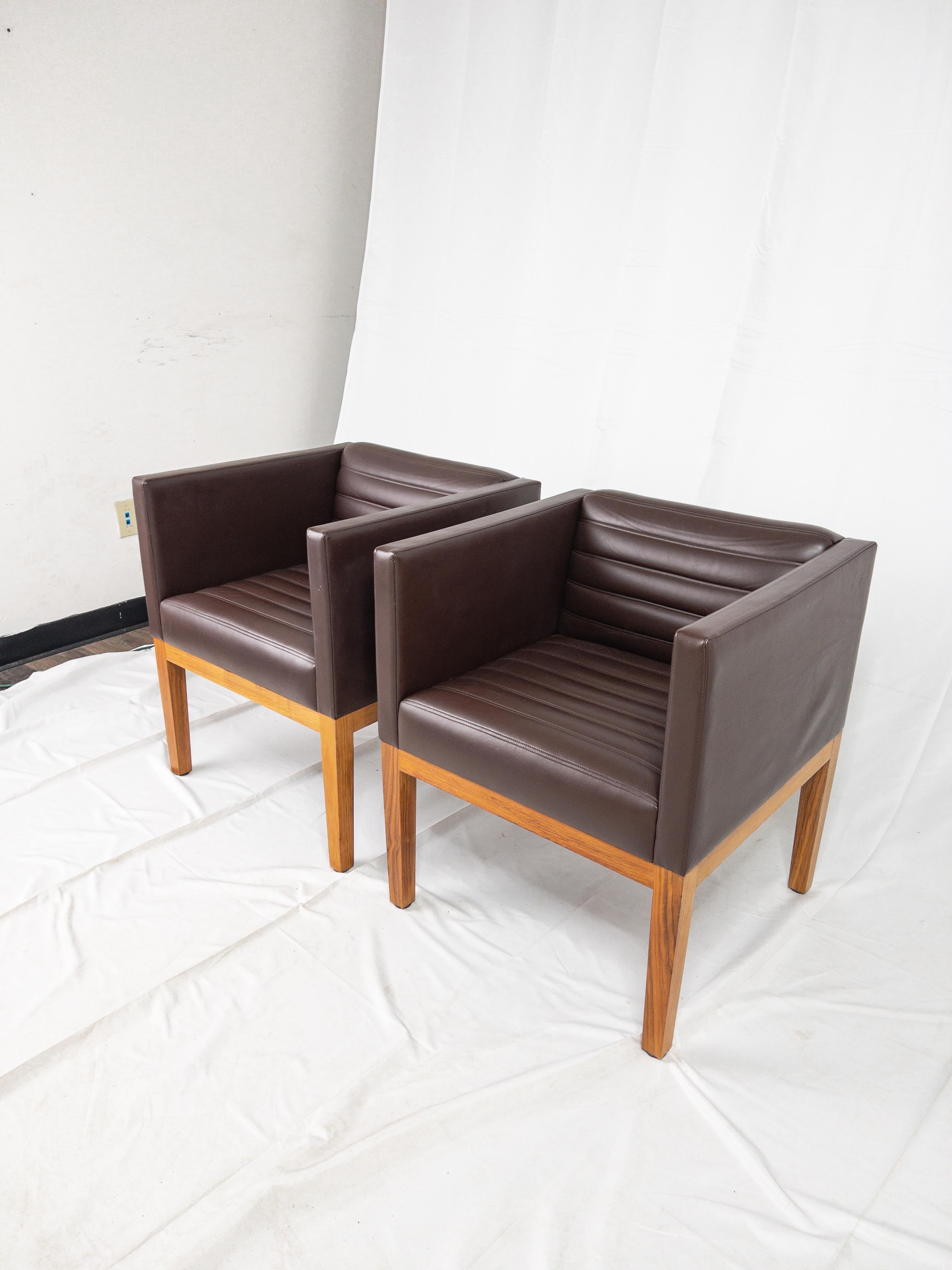 Exemplifying the pinnacle of Mid Century design, the Fabulous Pair of Leather Arm Chairs, crafted by the renowned LINLEY London, is a symphony of elegance and innovation. These chairs transcend time with their sleek lines, marrying classic