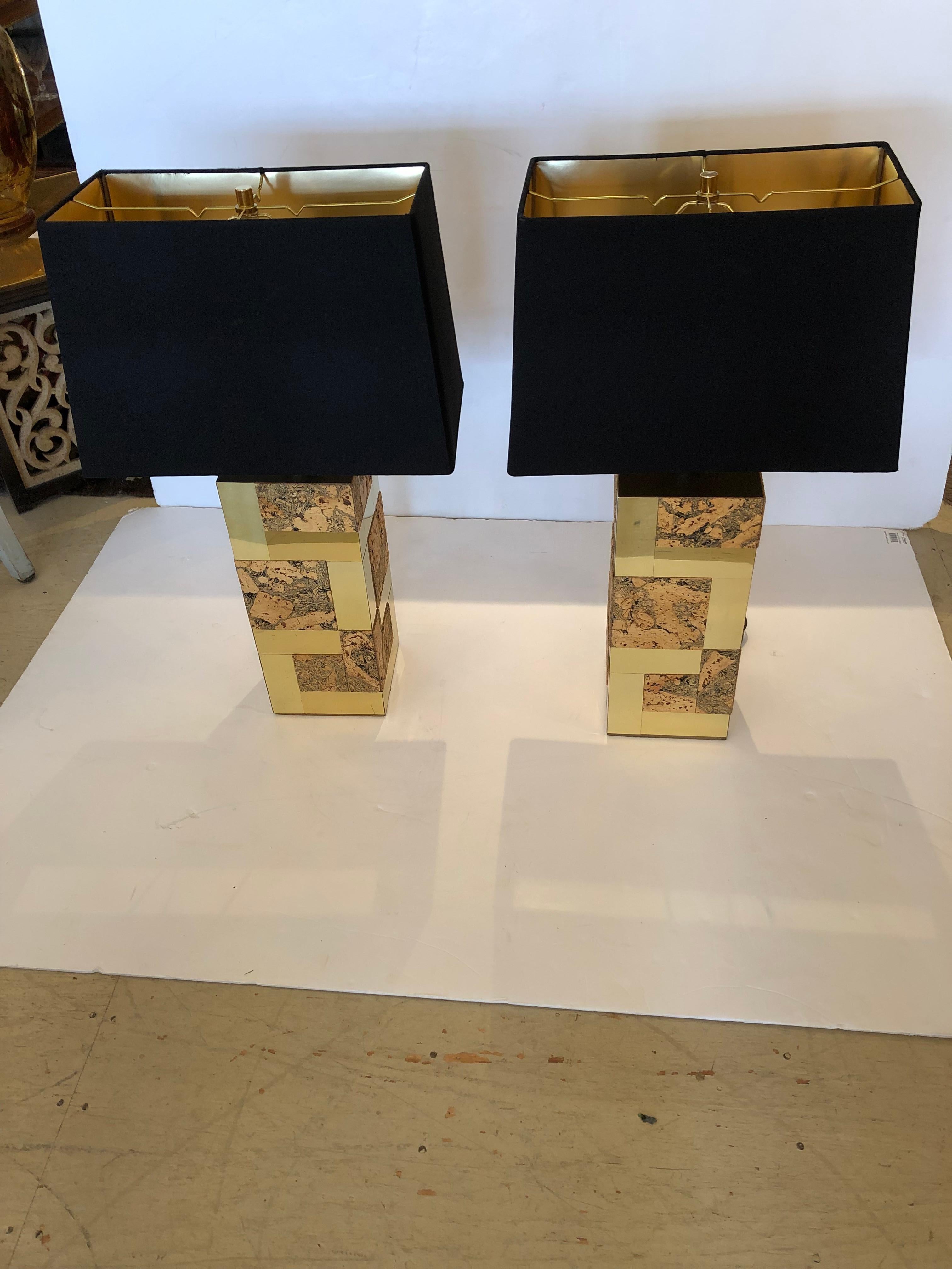 A rare and iconic pair of brass and cork cityscape elongated cube table lamps attributed to Paul Evans. We believe them to be authentic but no markings.
Chunky and fabulous! Brand new top of the line black shades with interior gold metallic