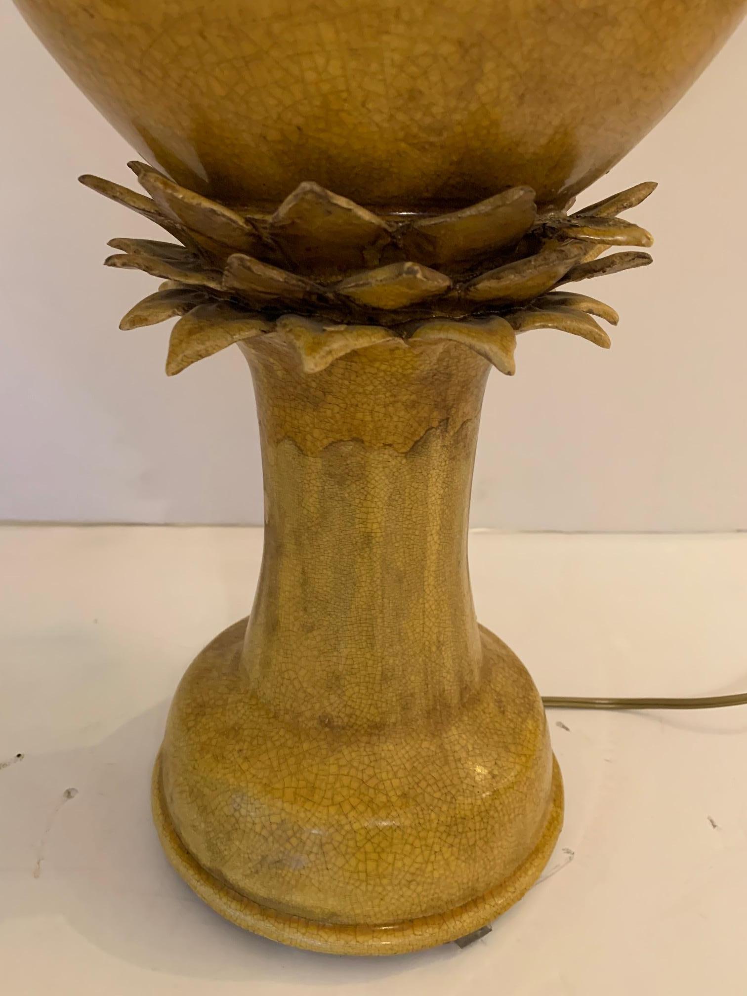 Fabulous pair of ochre colored ceramic jars custom made into lamps having wonderful; shape and decorative petal like forms in the center. New shades and rich looking brass finials.
 