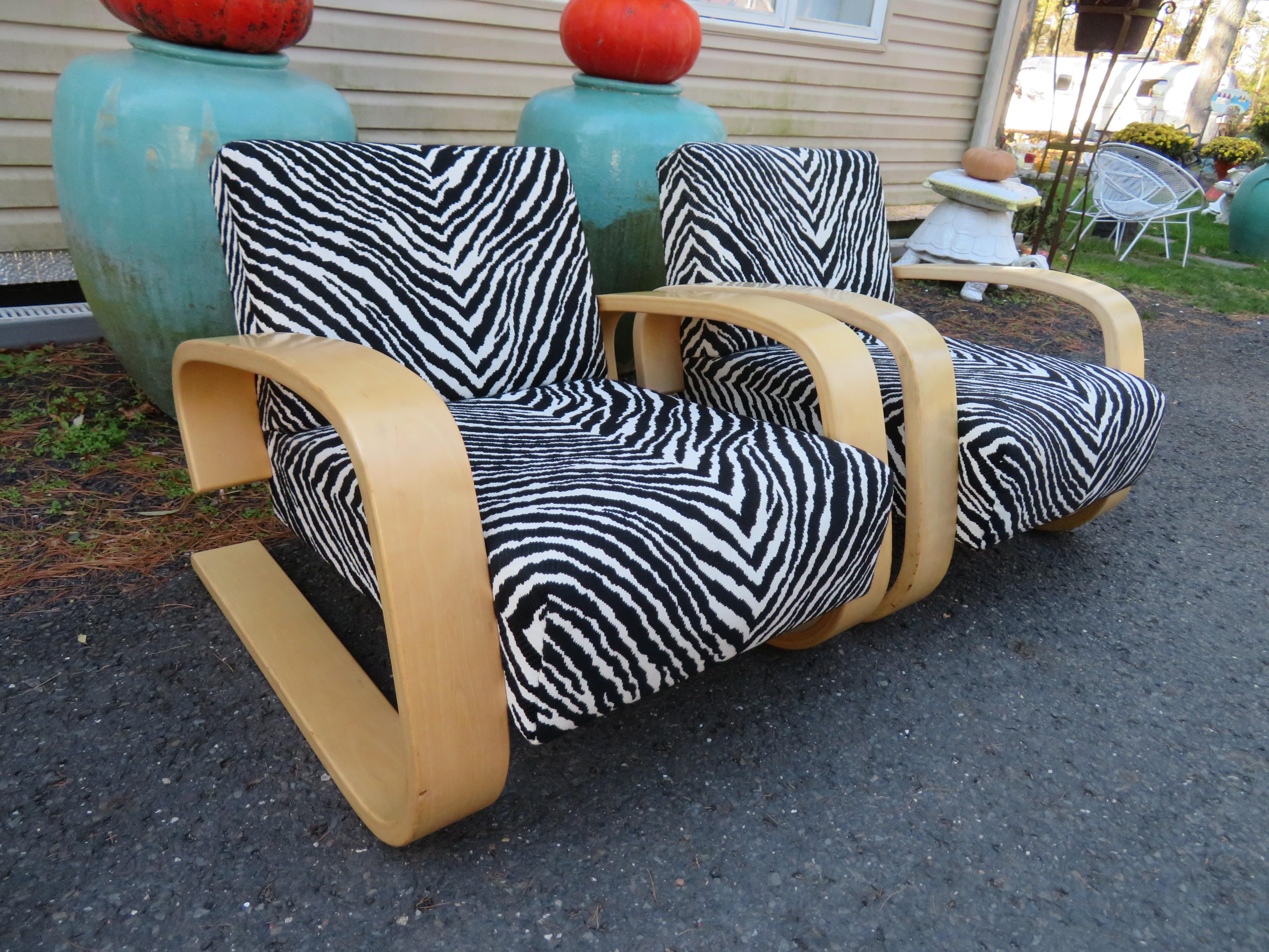 Fabulous pair of Alvar Aalto zebra print Tank chairs. This pair is circa 80s and are in very nice vintage condition. The armchair 400, designed by Alvar Aalto and better known as Tank, is one of the absolute milestones in furniture design of the