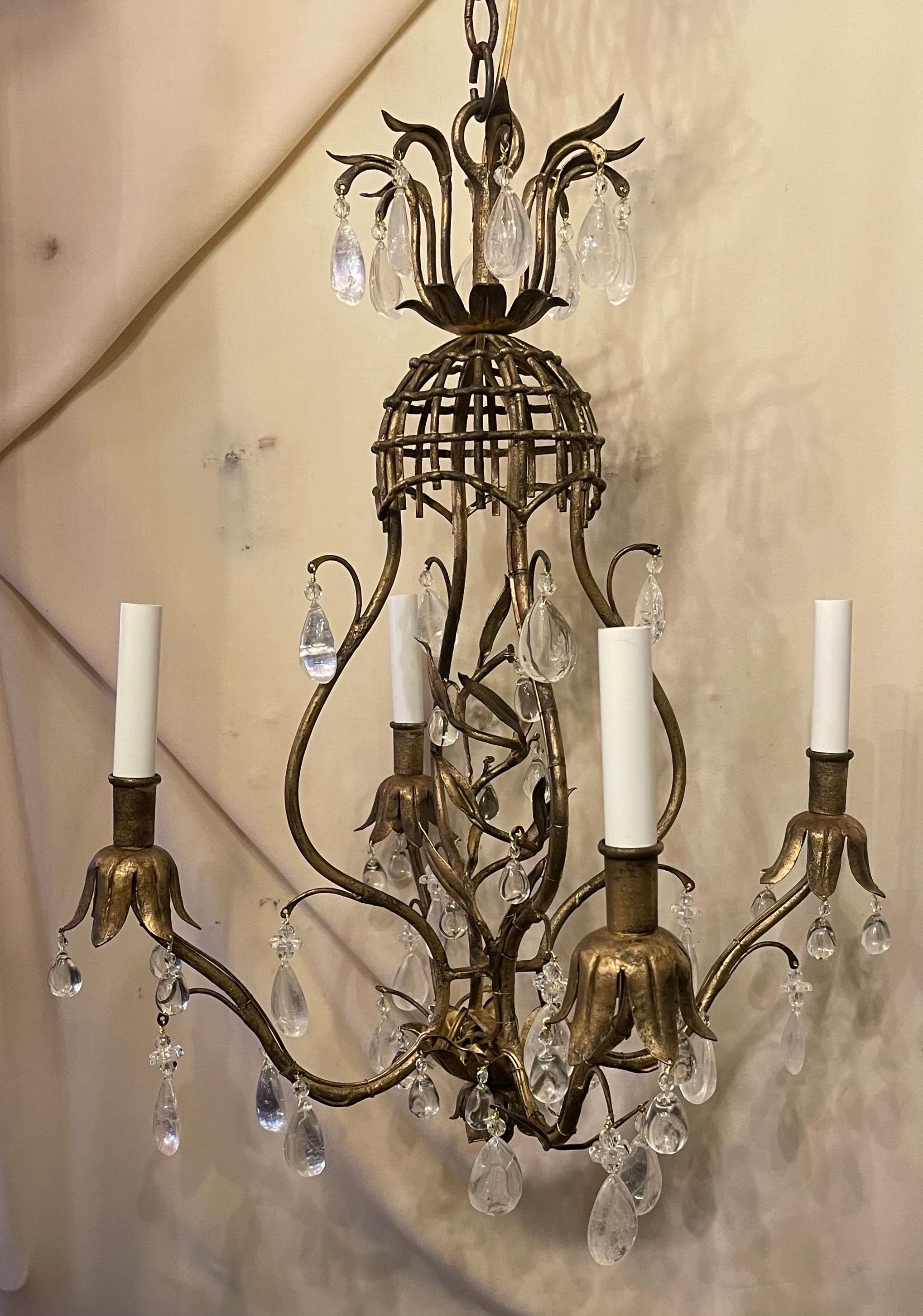 A fabulous petite four light Maison Baguès style rock crystal gold gilt french chandelier completely rewired for us with new sockets and accompanied by chain and canopy.