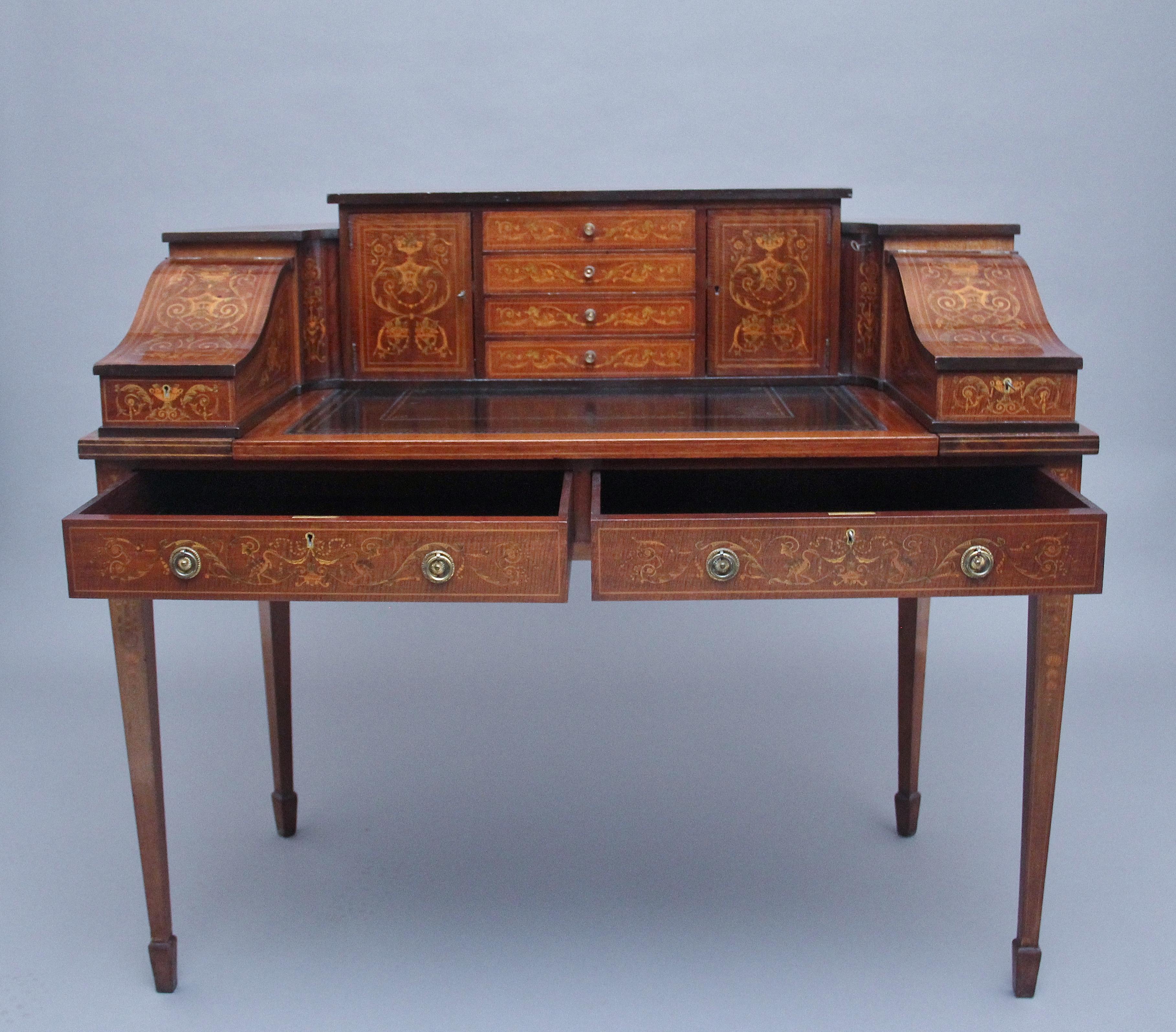A fabulous quality freestanding early 20th Century mahogany and inlaid Carlton house desk, the super structure comprising of four mahogany inlaid drawers at the centre with original brass turned knob handles, cupboards either side with workable lock