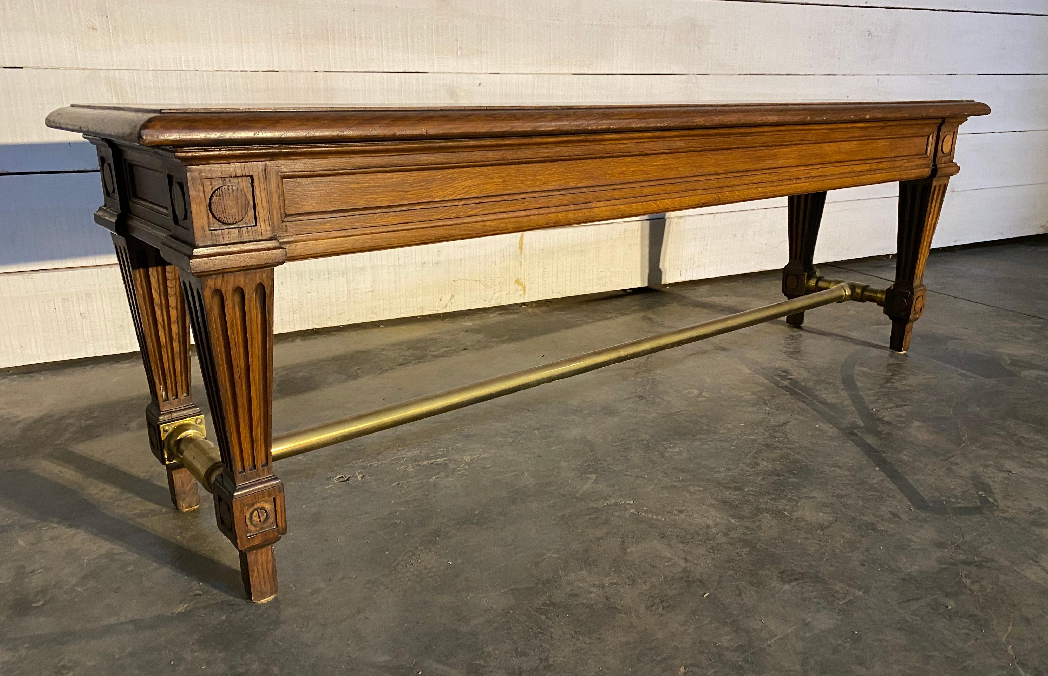 Perhaps one of the finest hall benches I have ever seen. This came from the bank of France in Paris and is of excellent quality and dating to the end of the 19th century very arts and crafts in design. Made from solid oak with a brass stretcher.