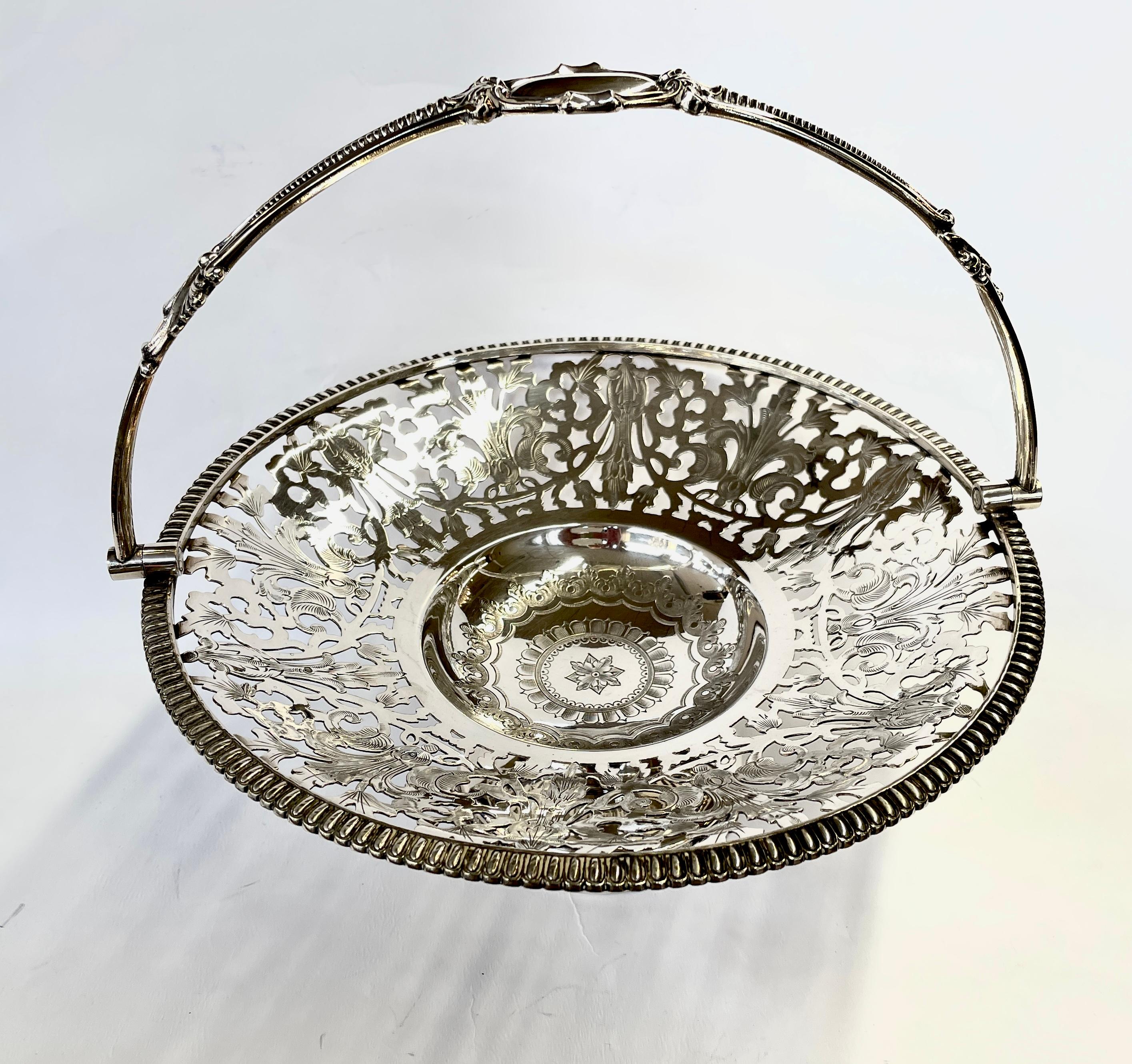 Fabulous quality extraordinary hand engraved and pierced round cake, bread or fruit basket. Also useful for flower arrangements (if a liner is used). Not only is the basket exceptionally hand-pierced, the pierced areas are bright-cut hand engraved