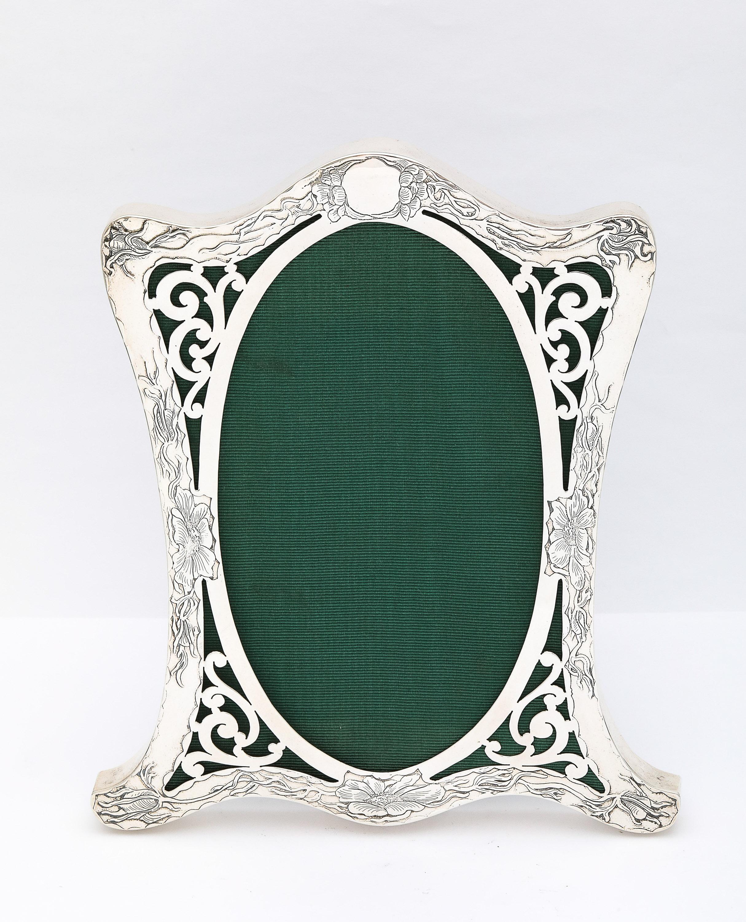 Fabulous, rare, sterling silver, Art Nouveau period picture frame, Thomas Brogan and Co., New York, Ca. 1895. The frame is acid-etched, having Art Nouveau-style flowers and vines that whip around the front of the frame. The cartouche at the top of