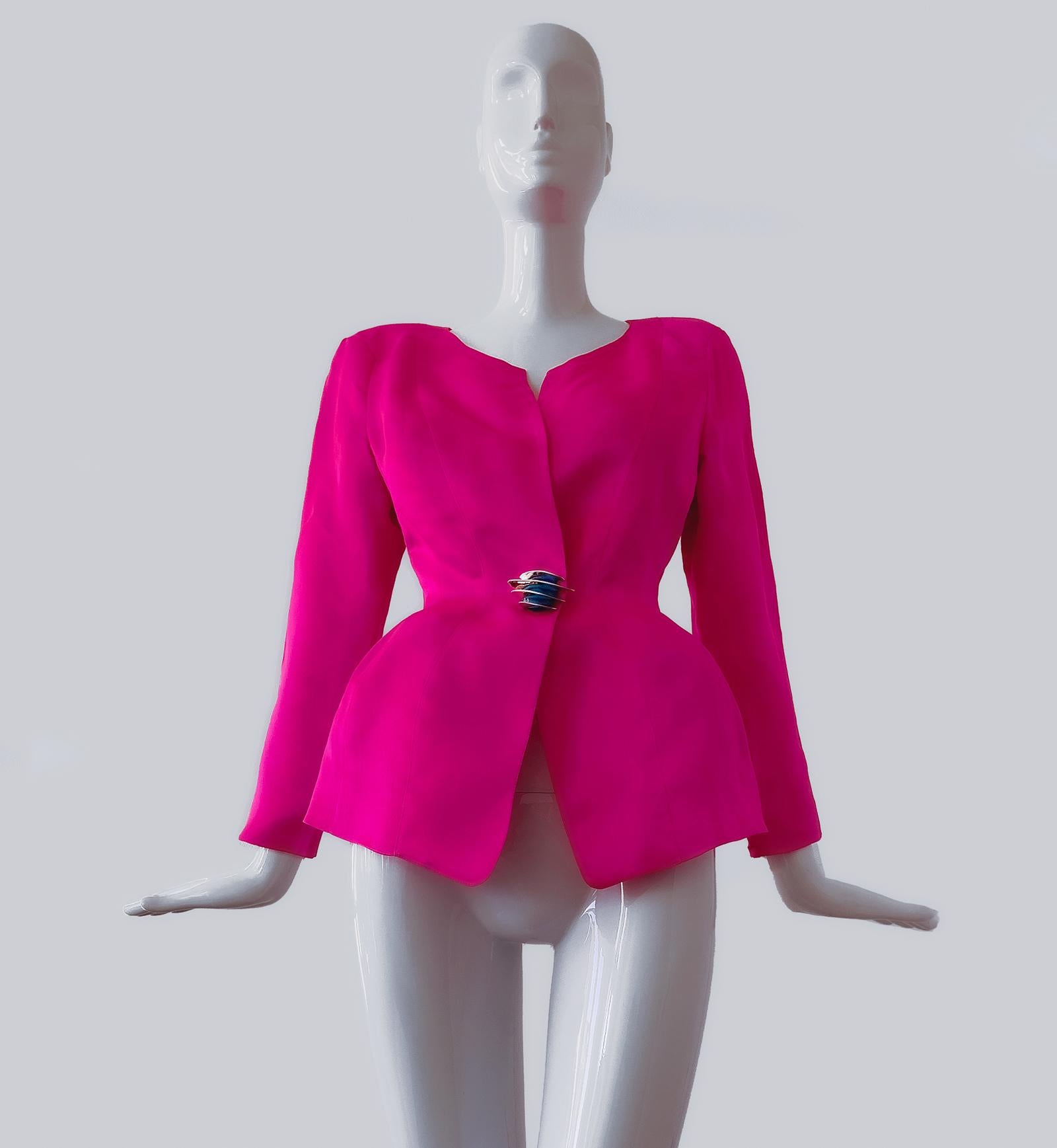 
Amazing and extremely rare Thierry Mugler jacket. 100% pure Silk in fabulous hot pink colour. Sculptural fitted waist and exageratted hips - truly a divine Thierry Mugler creation! Eyecatcher is the big silver metal and cabochon button element at