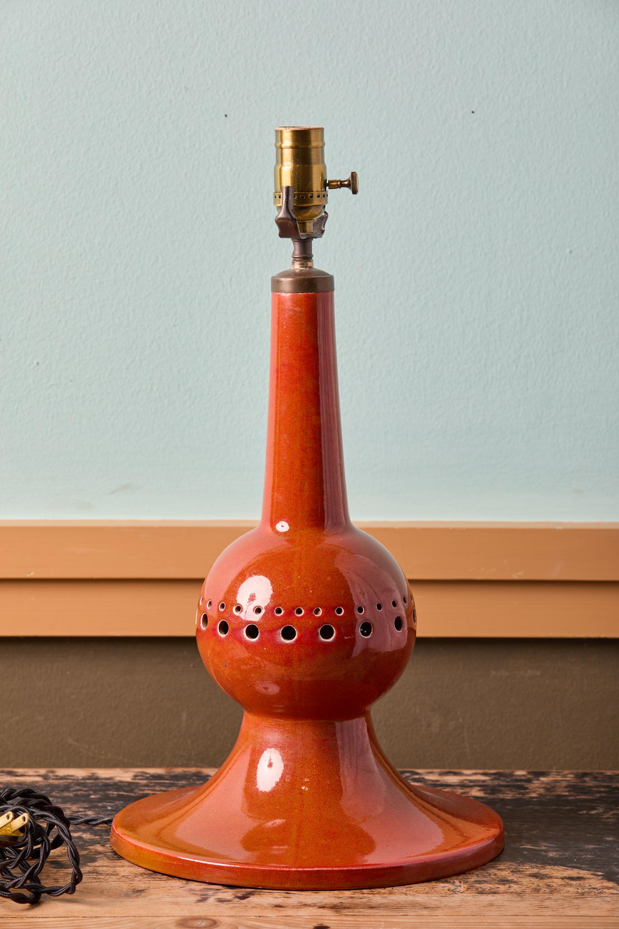 This lamp has the best shade of orange.  It is beautiful.  The lamp appears to be ceramic, but it is metal.  I very seldom find a lamp of this style.  The proportions are perfect. This lamp is appropriate for any room and any period. It is classic
