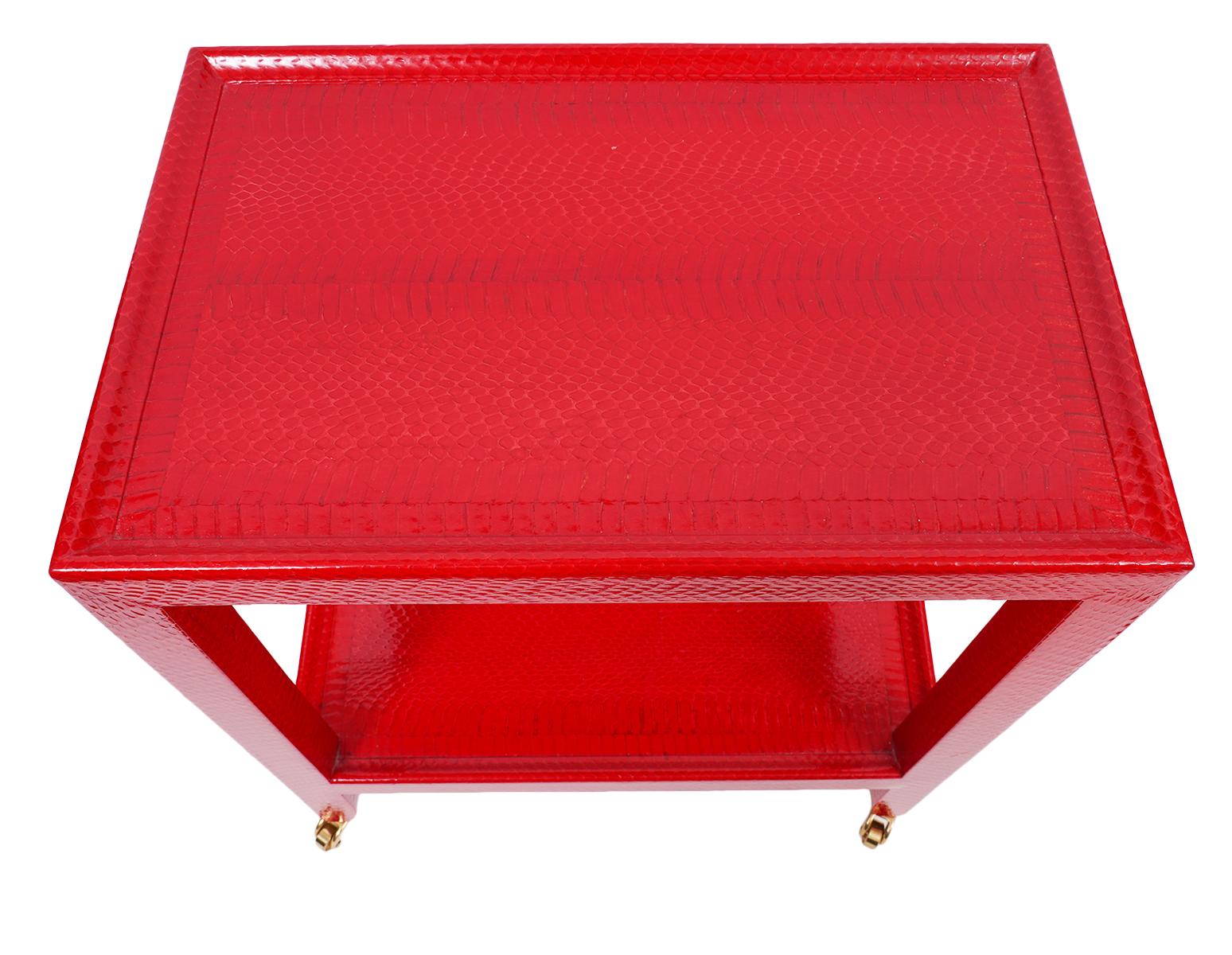 Mary Forssberg telephone table in a sharp red faux snakeskin. Styled after the Karl Springer telephone table. Label on the bottom.