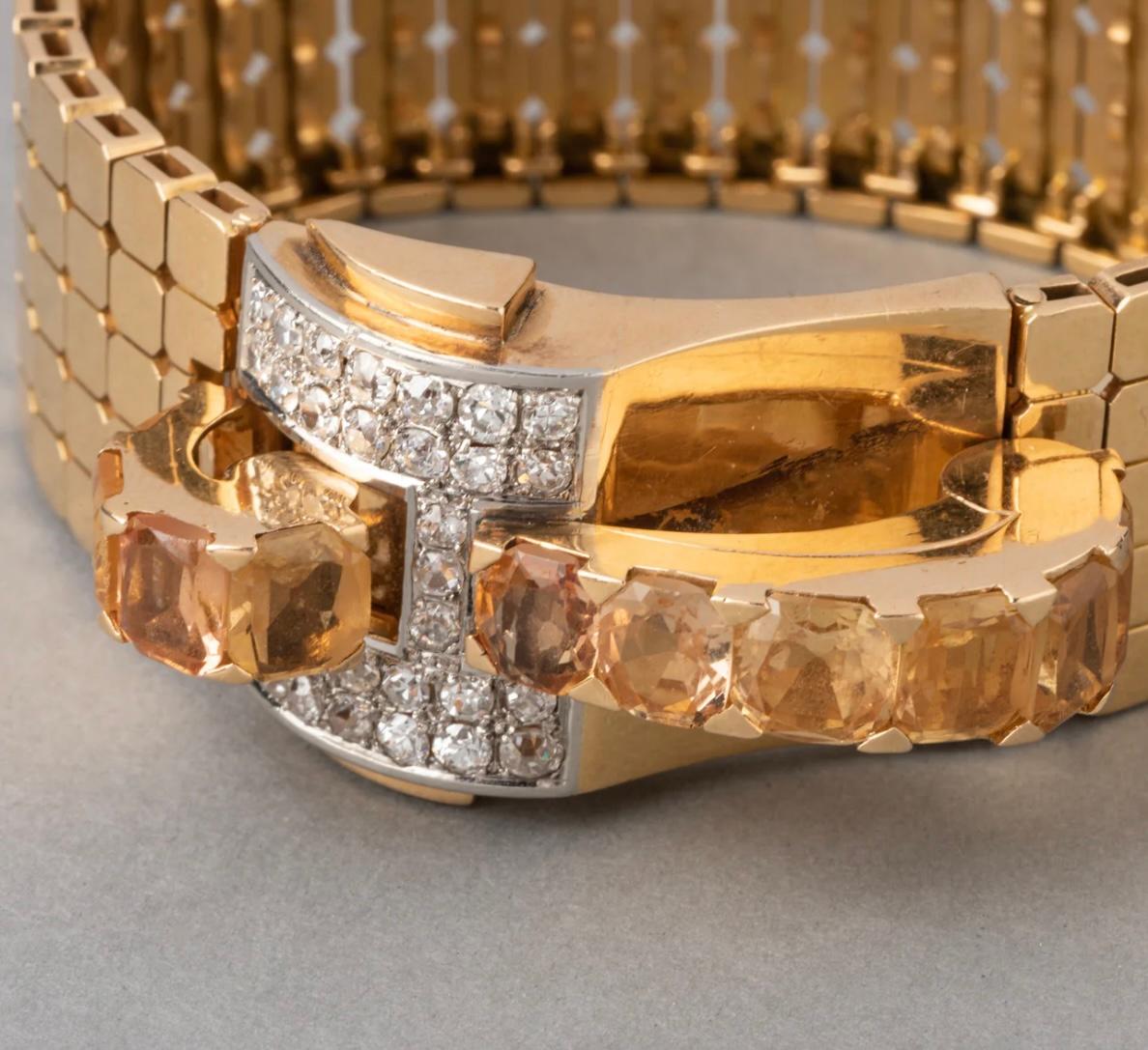 This is a French Retro Diamond and Citrine Buckle Bracelet from the 1940s. It is crafted from 18k yellow gold with 4 carats of Citrines and 2.5 carats of European Cut Diamonds. The bracelet weighs 79.10 grams and is definitely a statement piece!