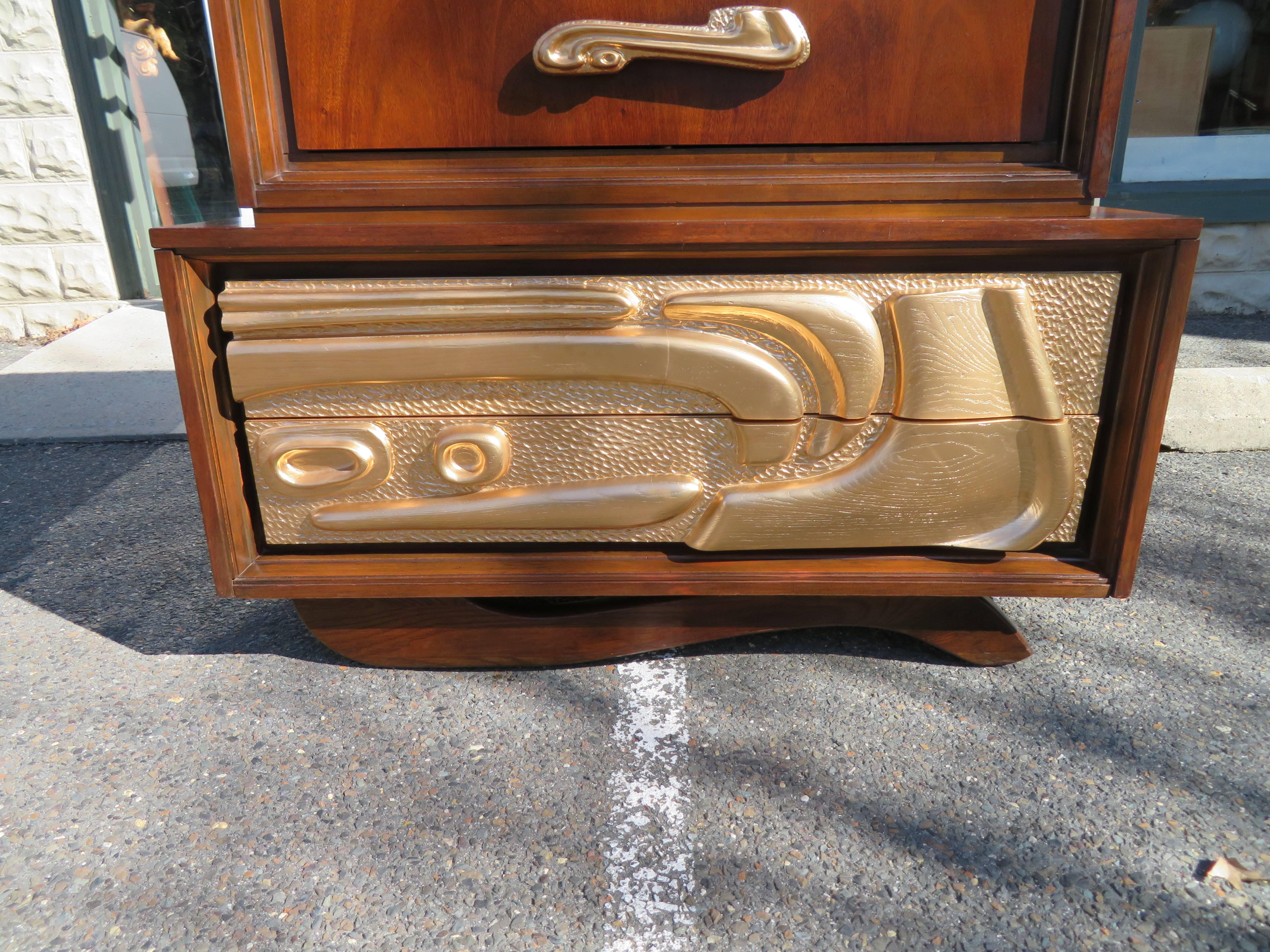 Fabulous sculptural Mid-Century Modern tall chest by Pulaski often attributed to Witco. This highboy is large and offers ample storage. Features four upper drawers with sculpted gold handles and two gilded gold bottom drawers-a real statement piece.