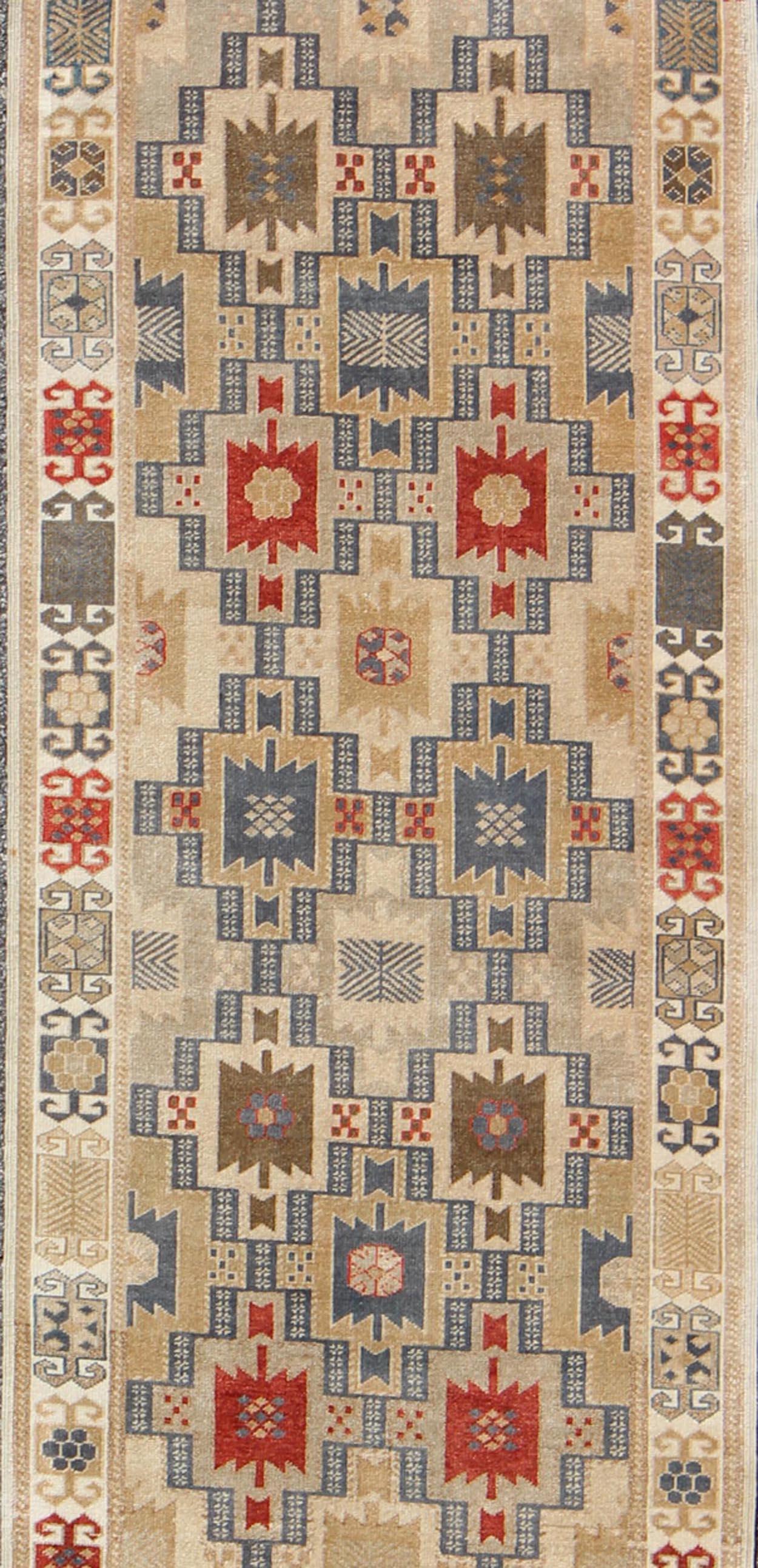 Exciting Multi-Colored Geometric Medallions in the field complemented by repeating geometric elements in the border. Antique Oushak Runner, rug tu-vey-4811, country of origin / type: Turkey / Oushak, circa 1930

Set on light camel and butter color