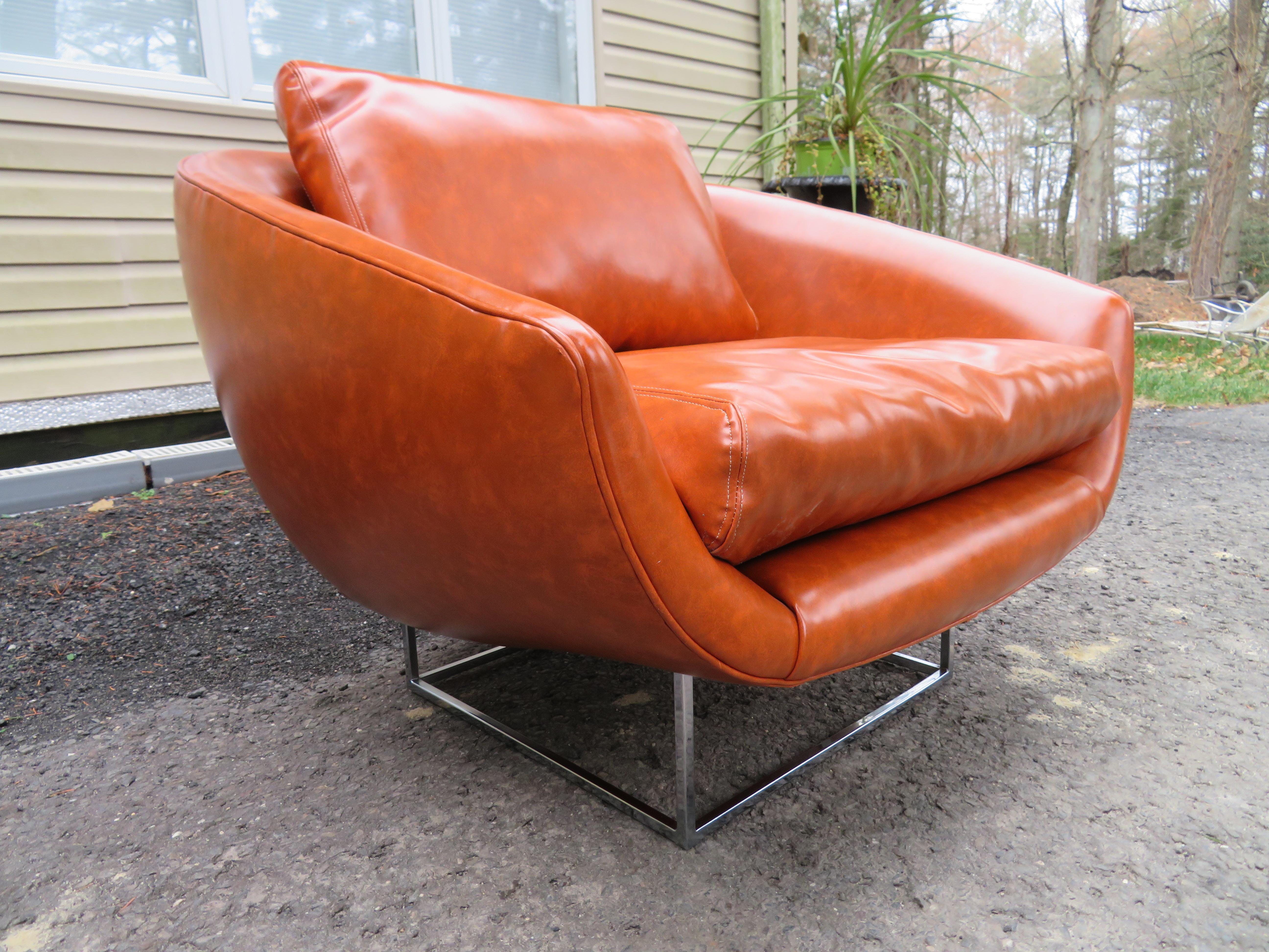 Fabulous signed Milo Baughman wide barrel back tub chair with thin chrome frame. This chair is in wonderful vintage condition retaining it's original caramel faux leather upholstery. This particular chair from Mr. Baughman is very rare and will be a