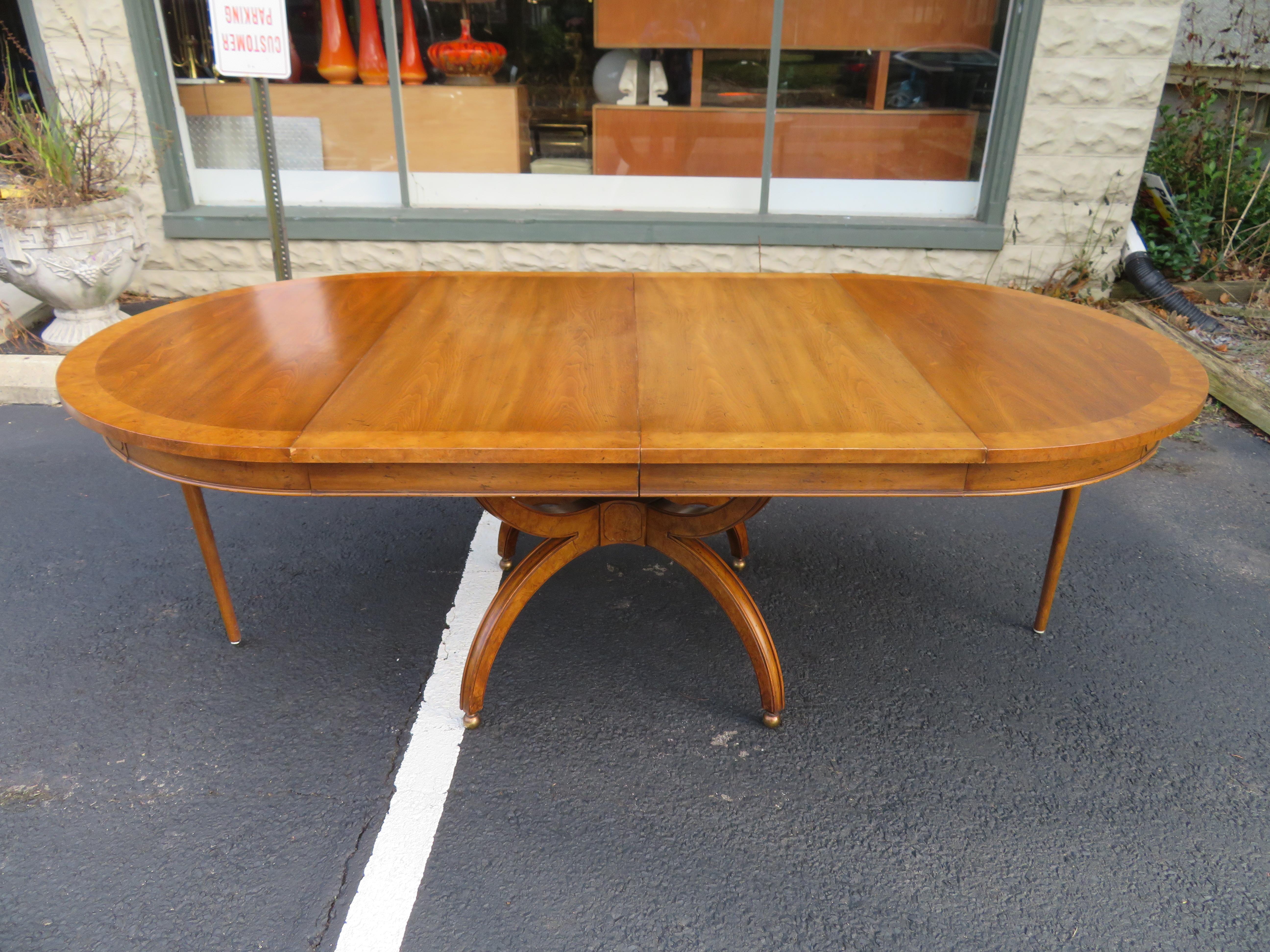 Fabulous William Doezema Biebermeier Amboyna and walnut dining table for Mastercraft. We love the round shaped top along with the cool brass sphere feet. This table has 2 good size leaves-over 20