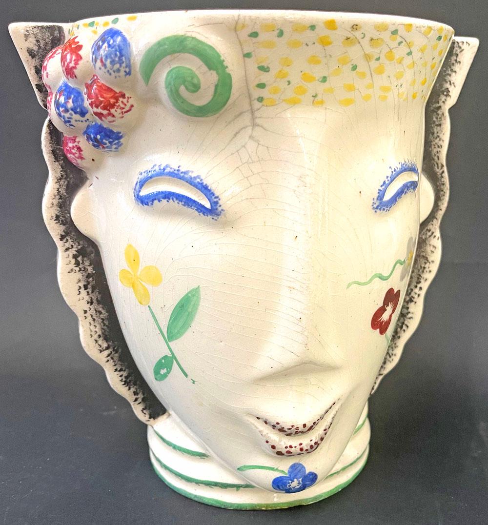 Fabulous and rare, this high-style Art Deco face jar, highlighted in tones of sky blue, lemon yellow and grassy green, was designed by Madeleine Sougez for the famed Primavera ceramic workshop in the 1930s.  Primavera was established by the famous