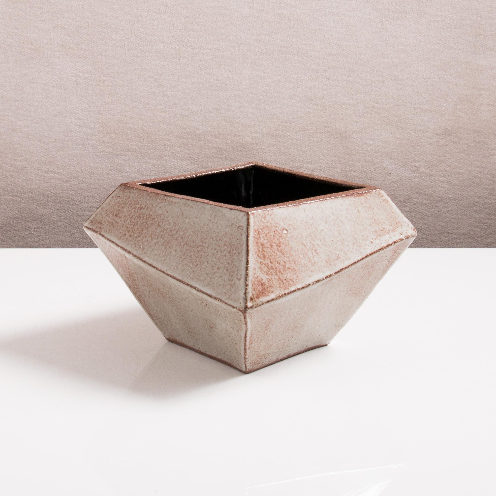 Inspired by midcentury Brutalist architecture, this ceramic vessel combines clean geometric lines with the warmth and individuality inherent in handmade work. It makes for a perfect modern cachepot or decorative bowl. Each piece is assembled