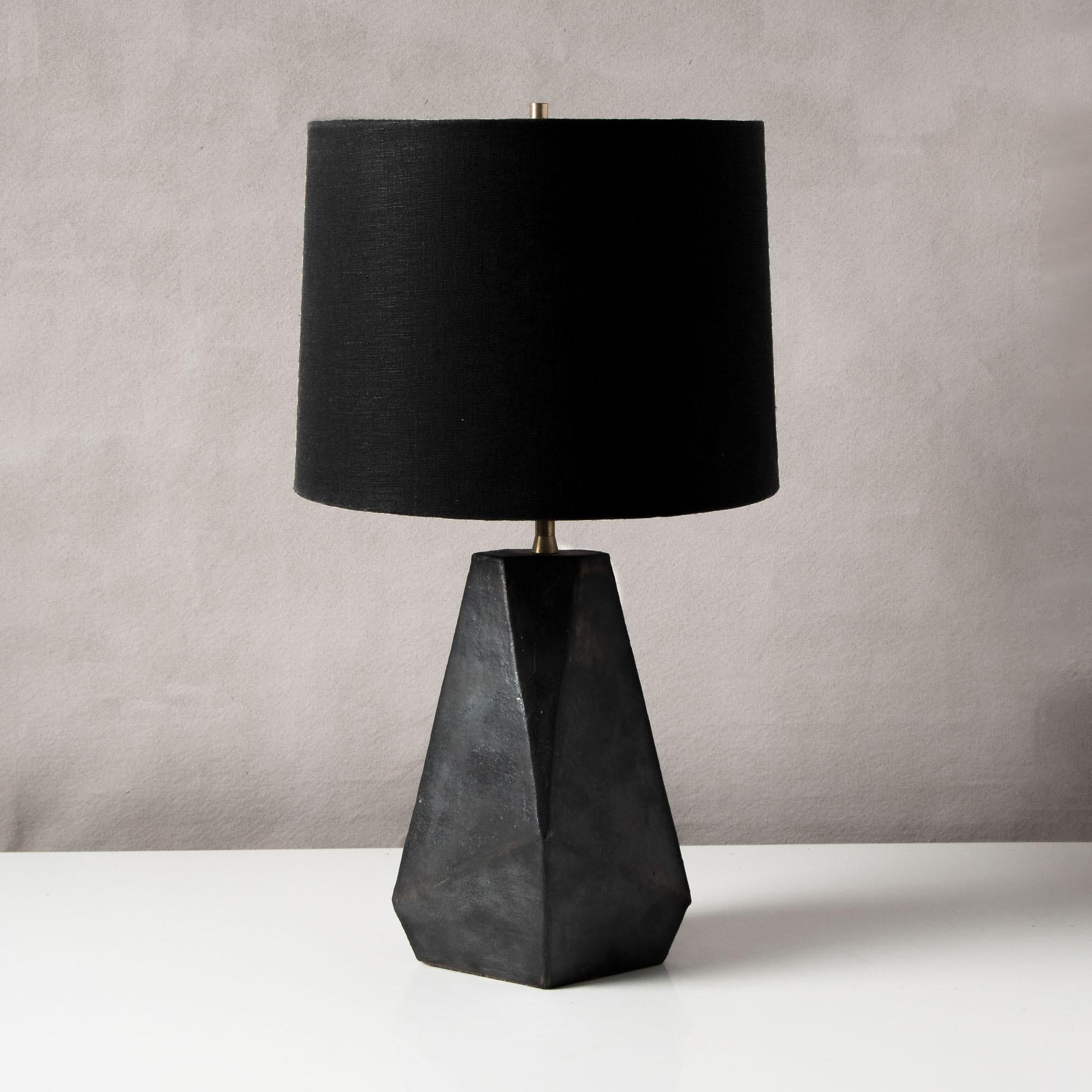 Inspired by midcentury Brutalist architecture, this tapered ceramic table lamp base combines clean geometric lines with the warmth and individuality inherent in handmade work. Each piece is assembled individually from flat sheets of clay, into a