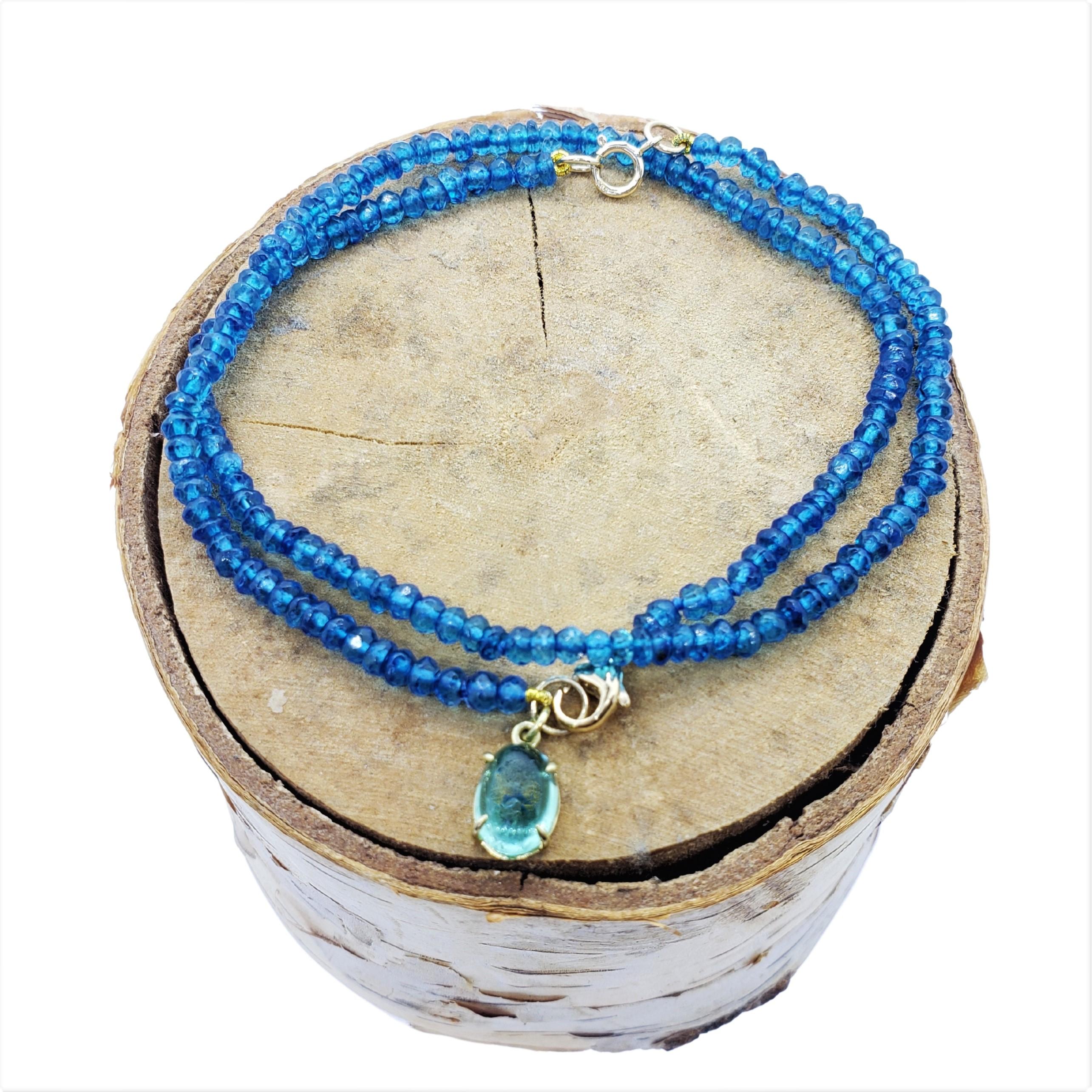 Shades of Blue in this exotic beaded bracelet with Apatite faceted beads and a handmade 18K open setting for the Oval clear Blue Tourmaline cabochon as drop off and 18K lobster clasp to complete the luxurious style. 
A perfect bracelet to stack with