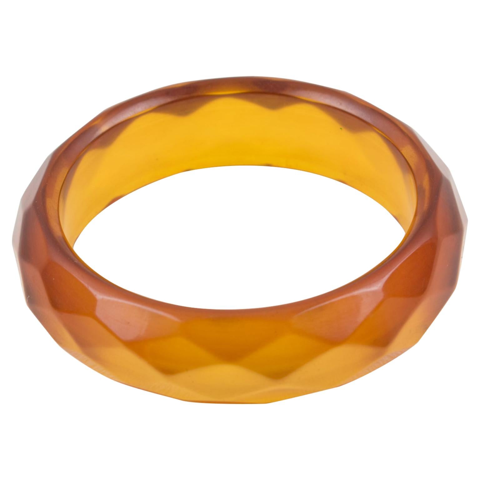 Lovely transparent orangeade Bakelite bracelet bangle. Chunky domed shape with deeply faceted and carved design all around. Intense orangeade tone, all transparent orange color with red overtone on edges. This Prystal quality piece has all the