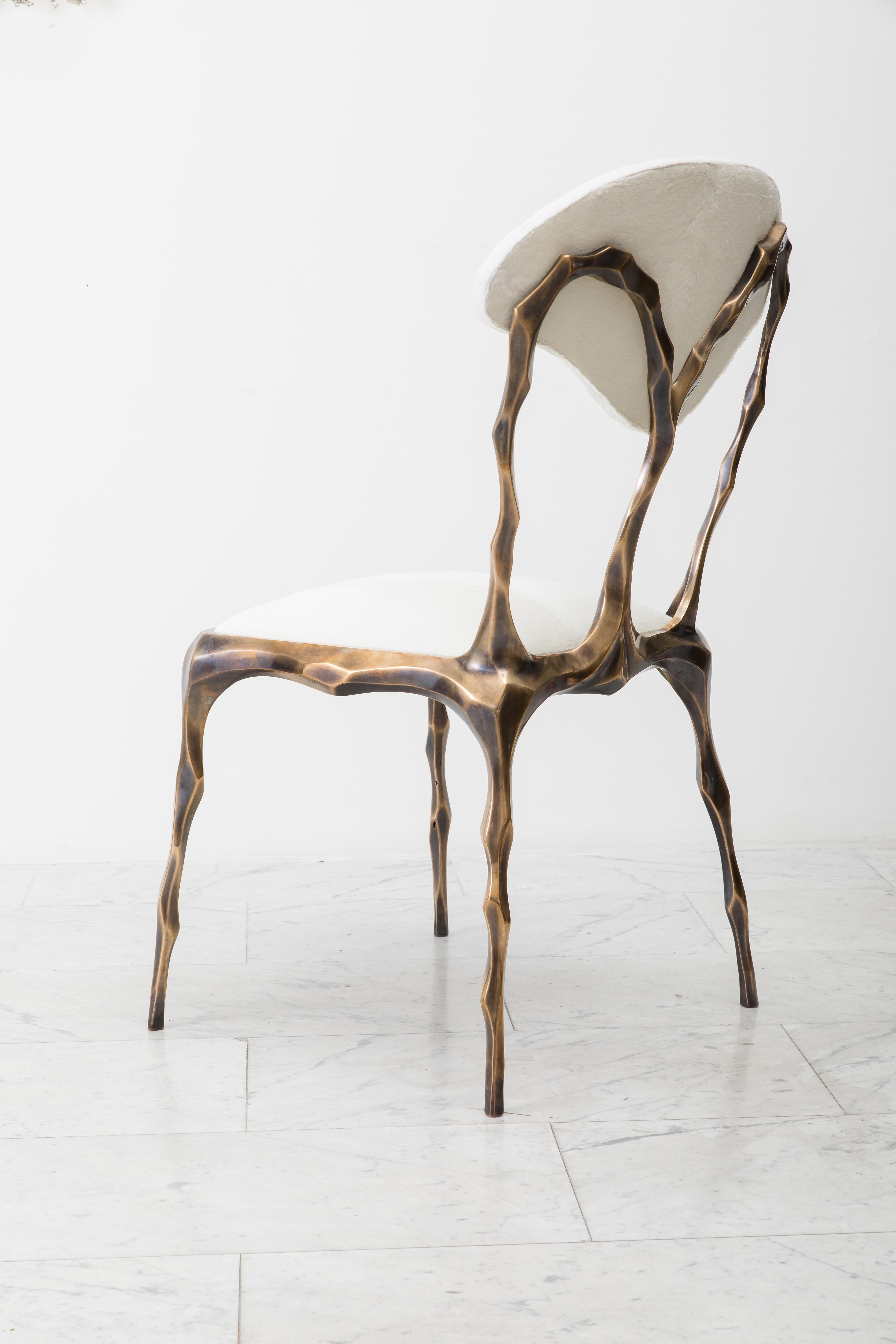 Taking inspiration from the twisting forms of seaweed and other natural materials, Haase hand-carves each element of his unique dining chair before casting it in his New York City Studio. The bronze components are then welded together by the artist