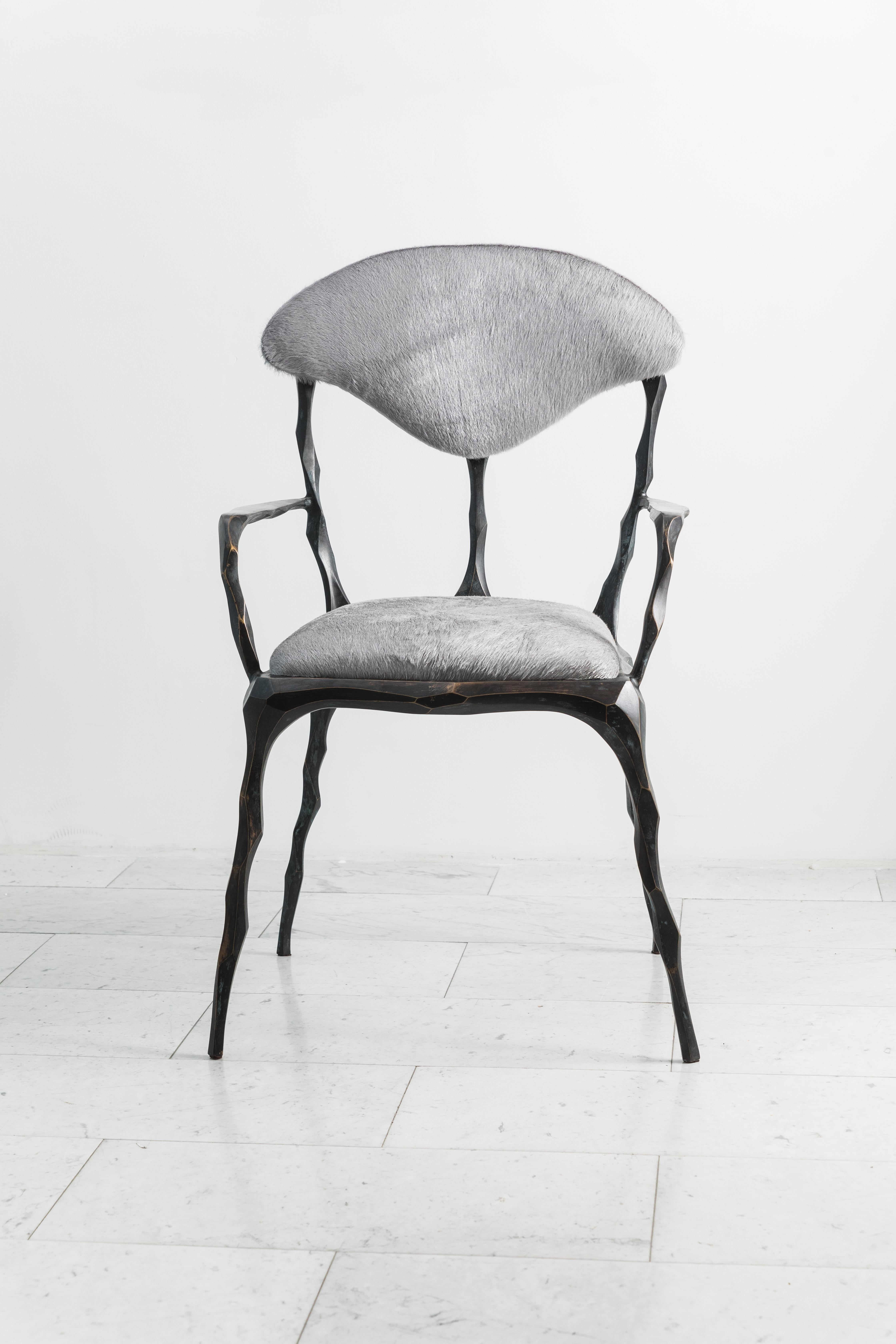 Taking inspiration from the twisting forms of seaweed and other natural materials, Haase hand-carves each element of his unique dining chair before casting it in his New York City studio. The bronze components are then welded together by the artist