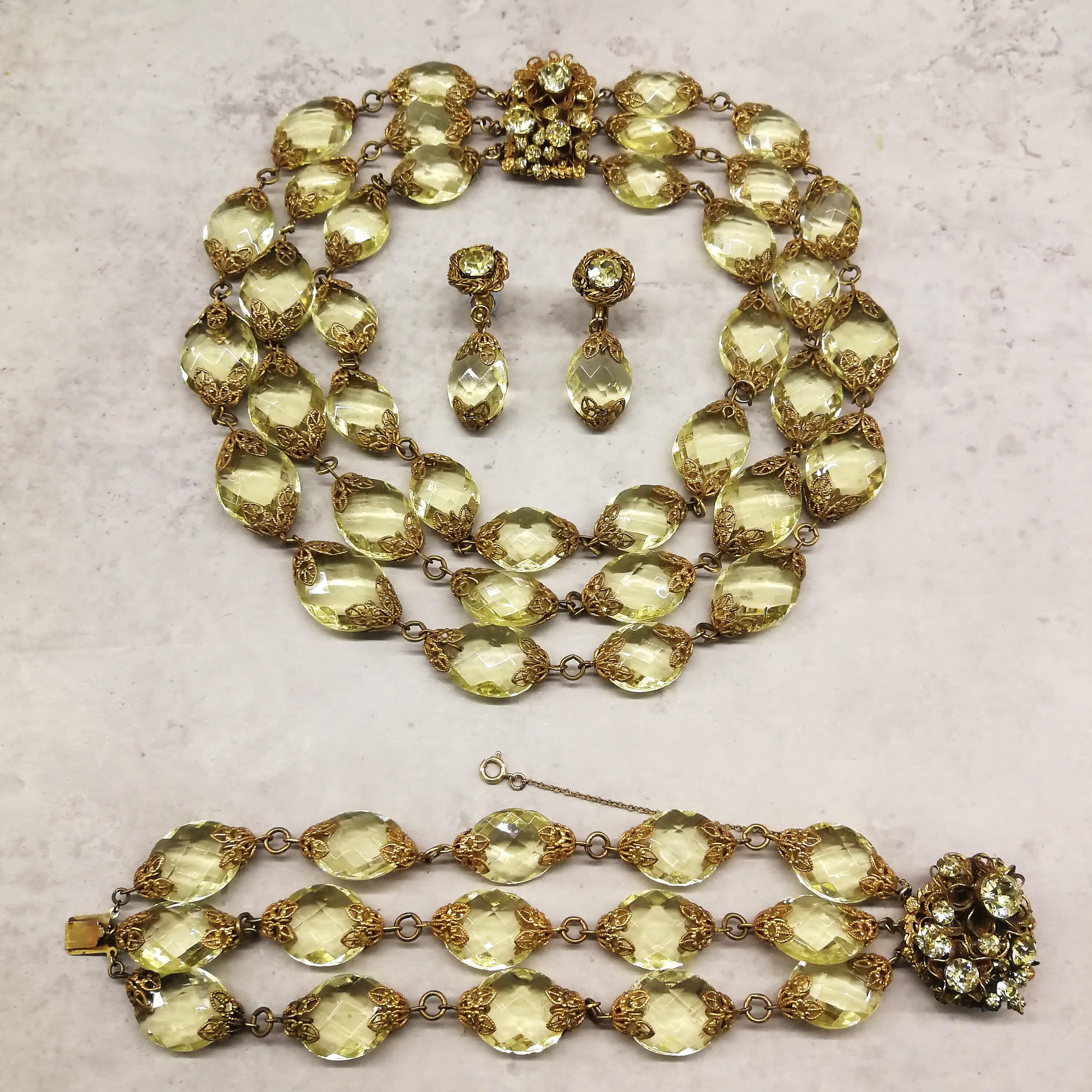 A very sumptuous and very glamorous parure, necklace, bracelet and earrings, from Miriam Haskell in the 1960s. Composed of faceted faux citrine ovals, held in gilt metal terminals, the clasp of both the necklace and the bracelet have typical Haskell