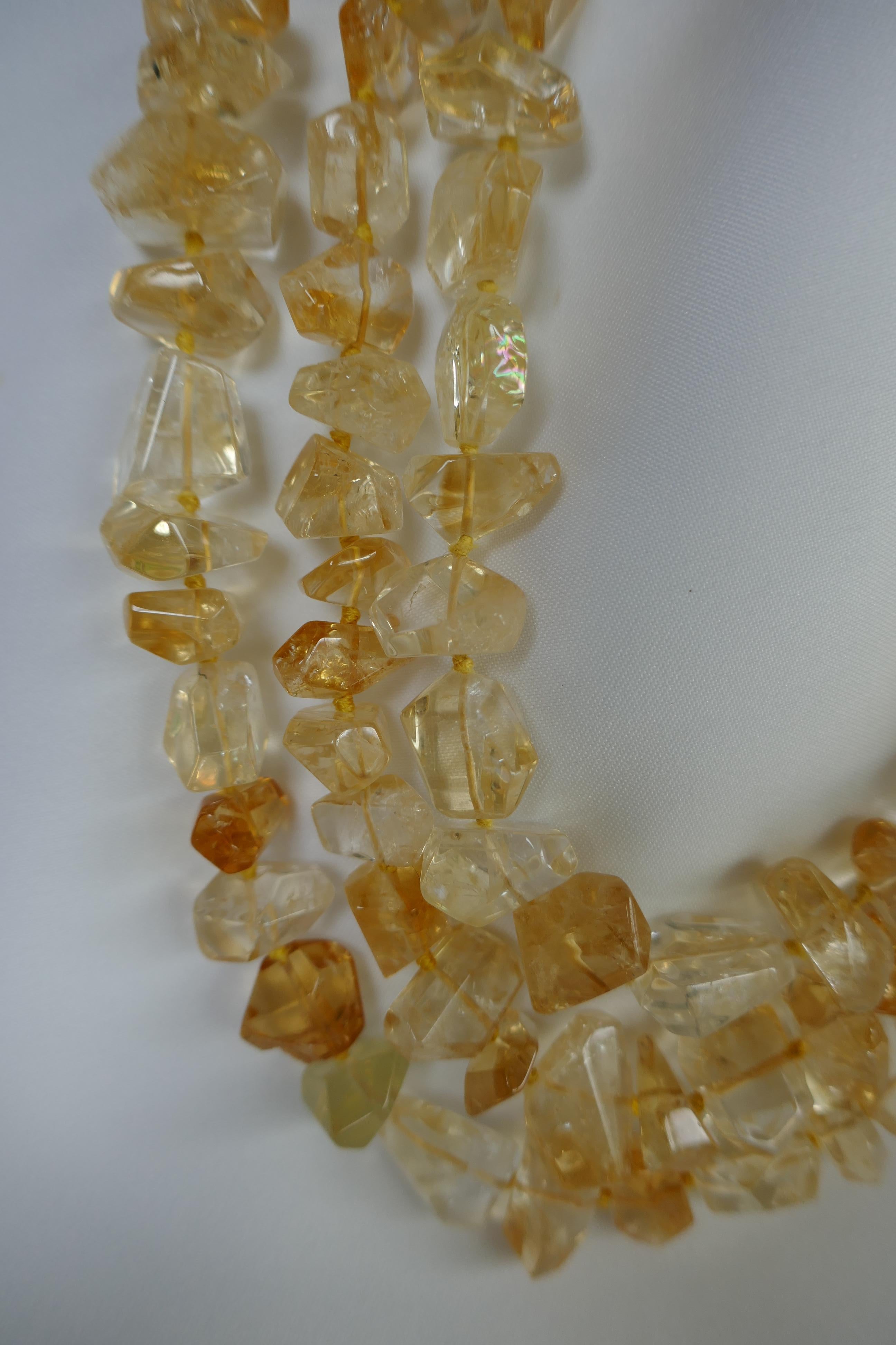 This three strand (multi) strand graduated citrine necklace is absolutely stunning. The citrine faceted nuggets have a lot of life and are beautiful. The necklace nest perfectly. The clasp is 925 vermeil silver. It is strung and knotted on yellow