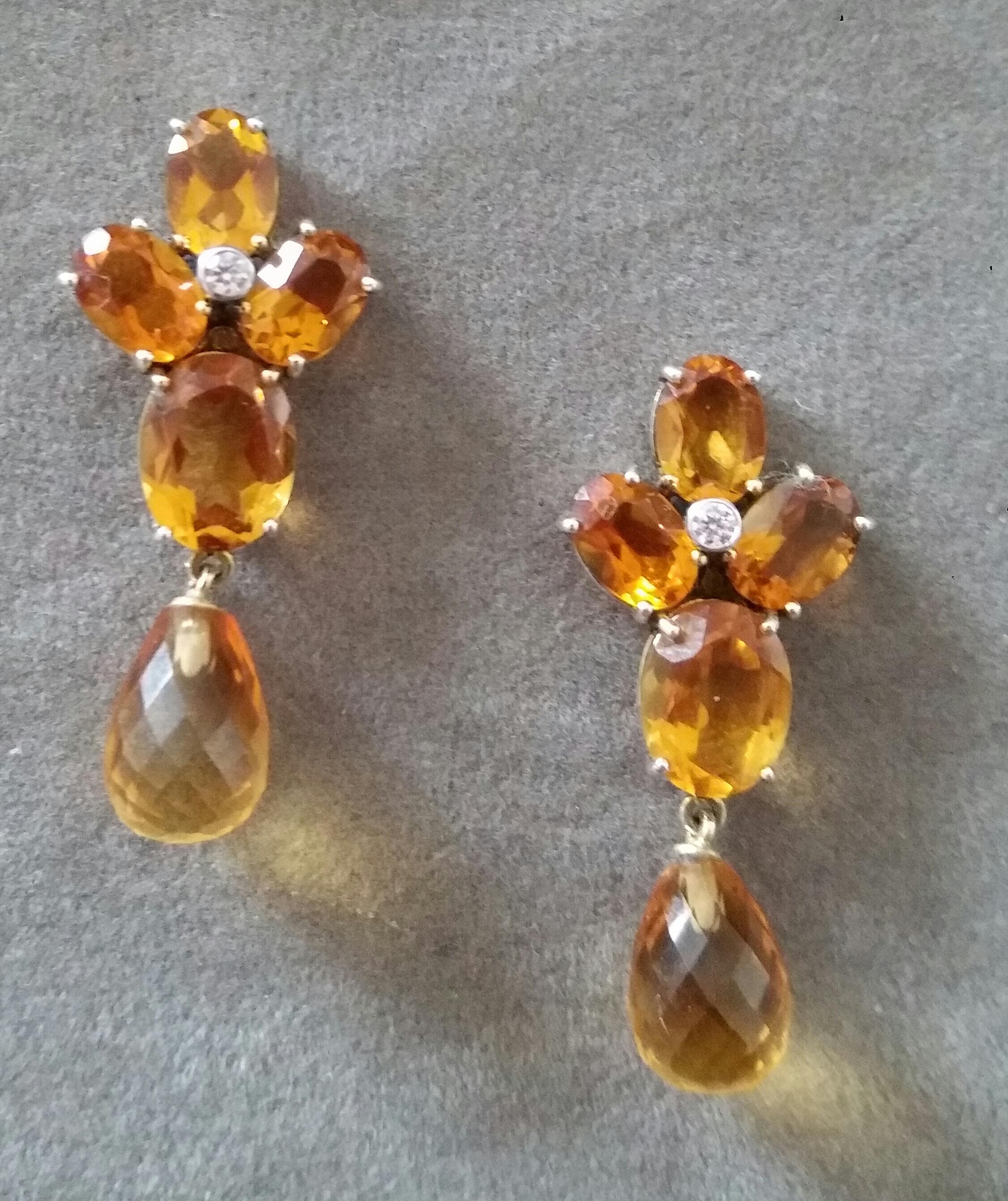 Elegant and completely handmade Earrings consisting of an upper part of 4 oval shape and nice Cognac color faceted Citrines set together in 14 Kt yellow gold with a small diamond in the center, at the bottom 2 faceted Round drop shape Citrines 