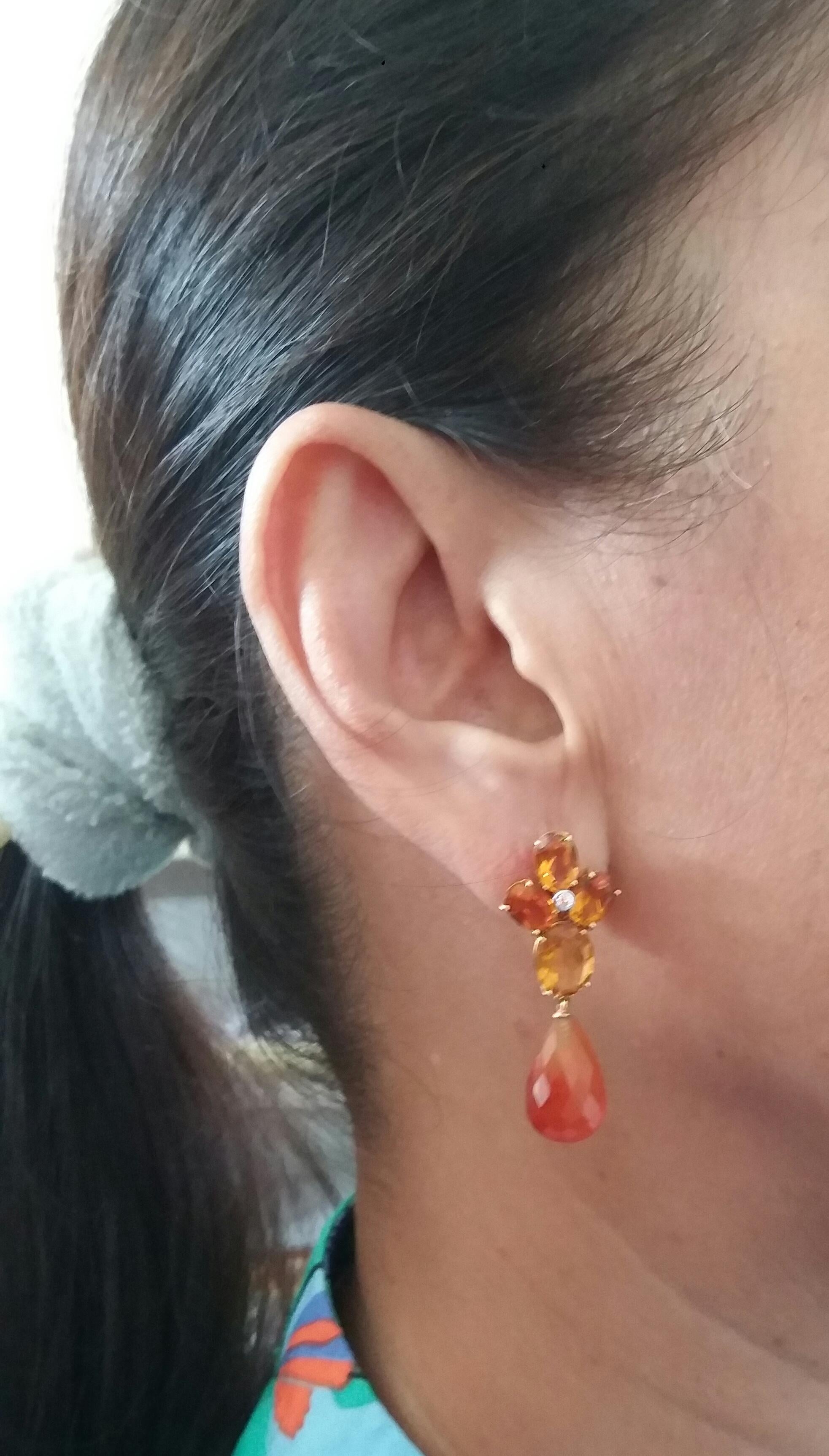 Elegant and completely handmade Earrings consisting of an upper part of 4 oval shape and nice Cognac color faceted Citrines set together in 14 Kt yellow gold with a small diamond in the center, at the bottom 2 Carnelian faceted drop shape measuring