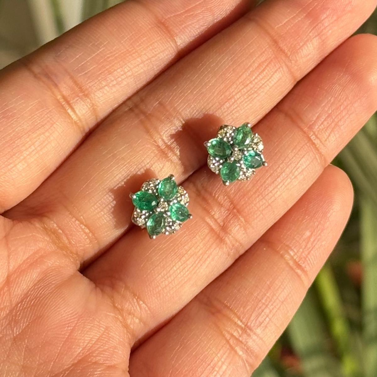 Faceted Emerald Diamond Flower Stud Earrings in sterling silver to make a statement with your look. You shall need stud earrings to make a statement with your look. These earrings create a sparkling, luxurious look featuring oval cut natural emerald