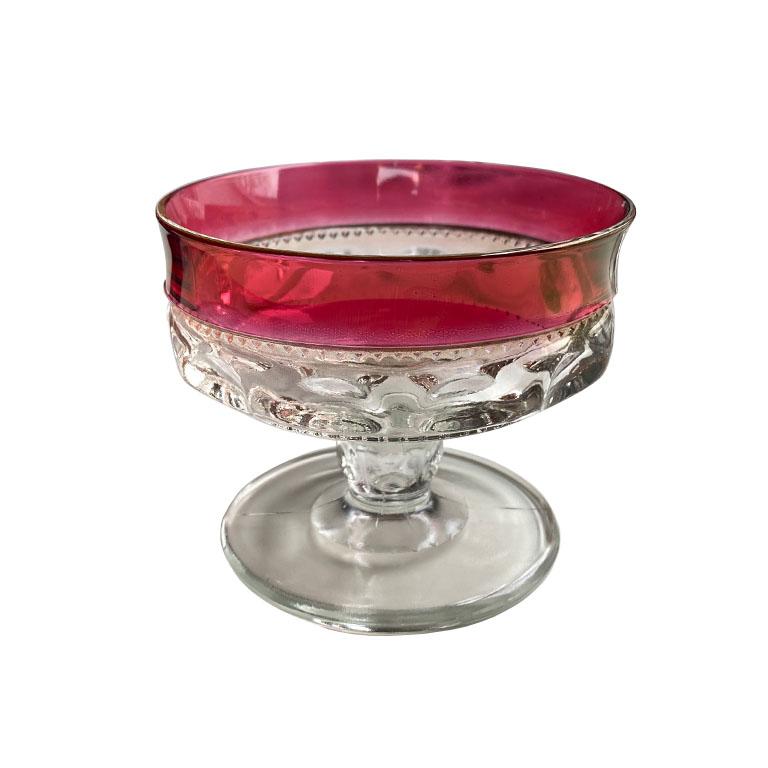 A lovely set of flashed cranberry thumbprint coupe glasses. With bright cranberry pink rims trimmed with gold, this pretty set will be great for champagne, or icecream. 

Dimensions:
3