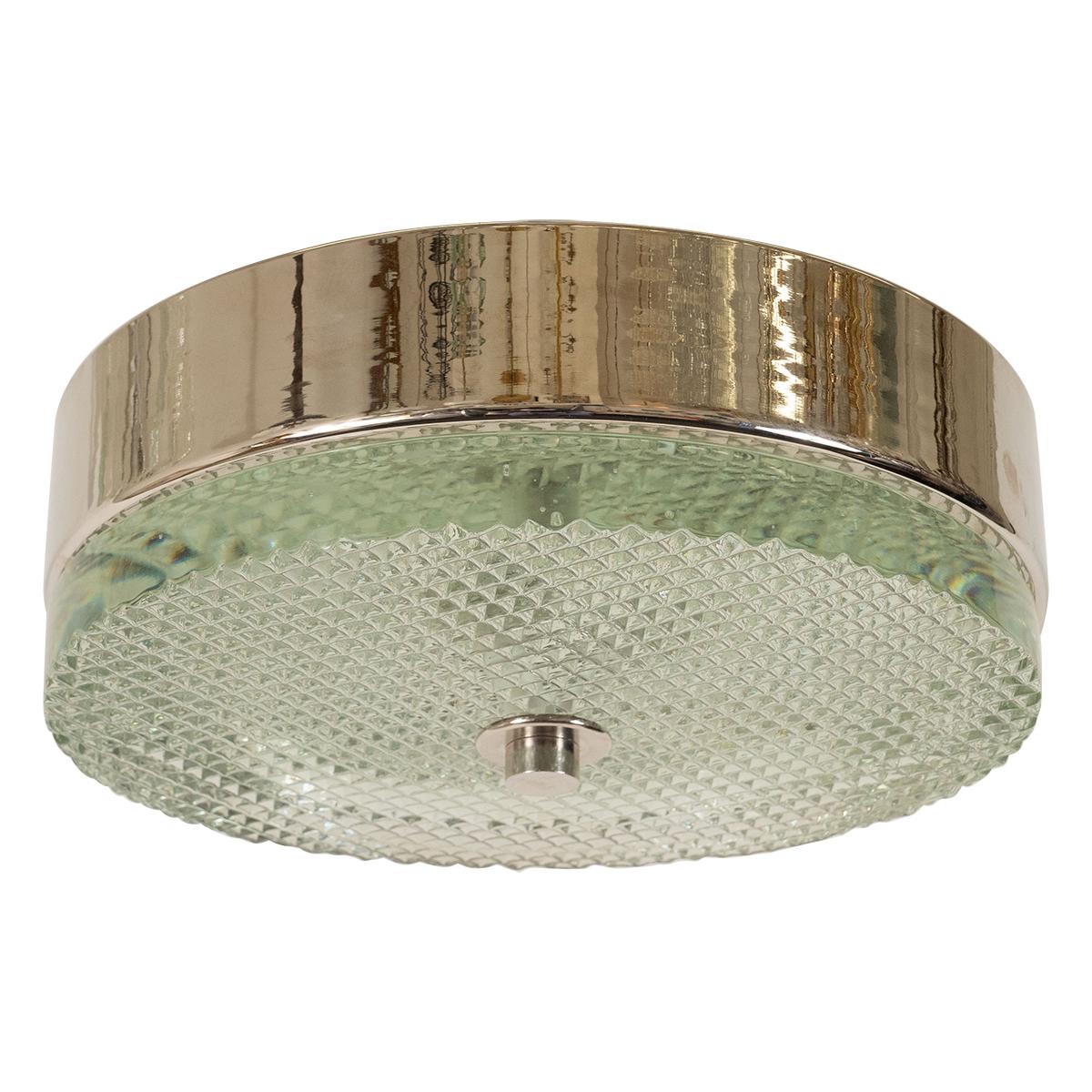 Round nickel flush mount fixture with faceted glass conforming shade.