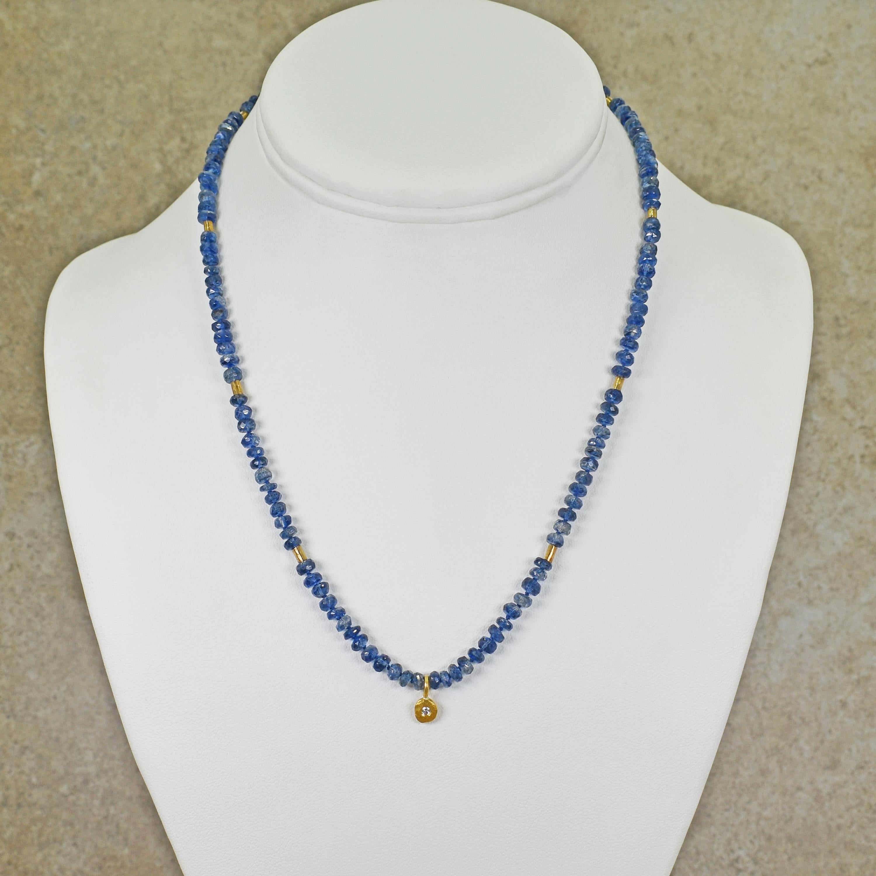 Beautiful blue faceted Kyanite beads, 22k yellow gold tube spacer beads, and a 22k gold and white, round Diamond pendant charm. Beaded necklace is 17.5 inches in length.
