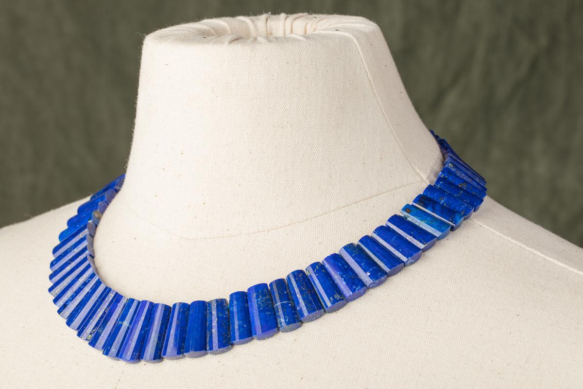 Stunning lapis lazuli necklace, all natural lapis with flecks of pyrite.  Unusually shaped lapis with multiple bevels along the top of the stone.  Superb color.  Slightly graduated.  The largest stone is just shy of an inch high and the smallest at