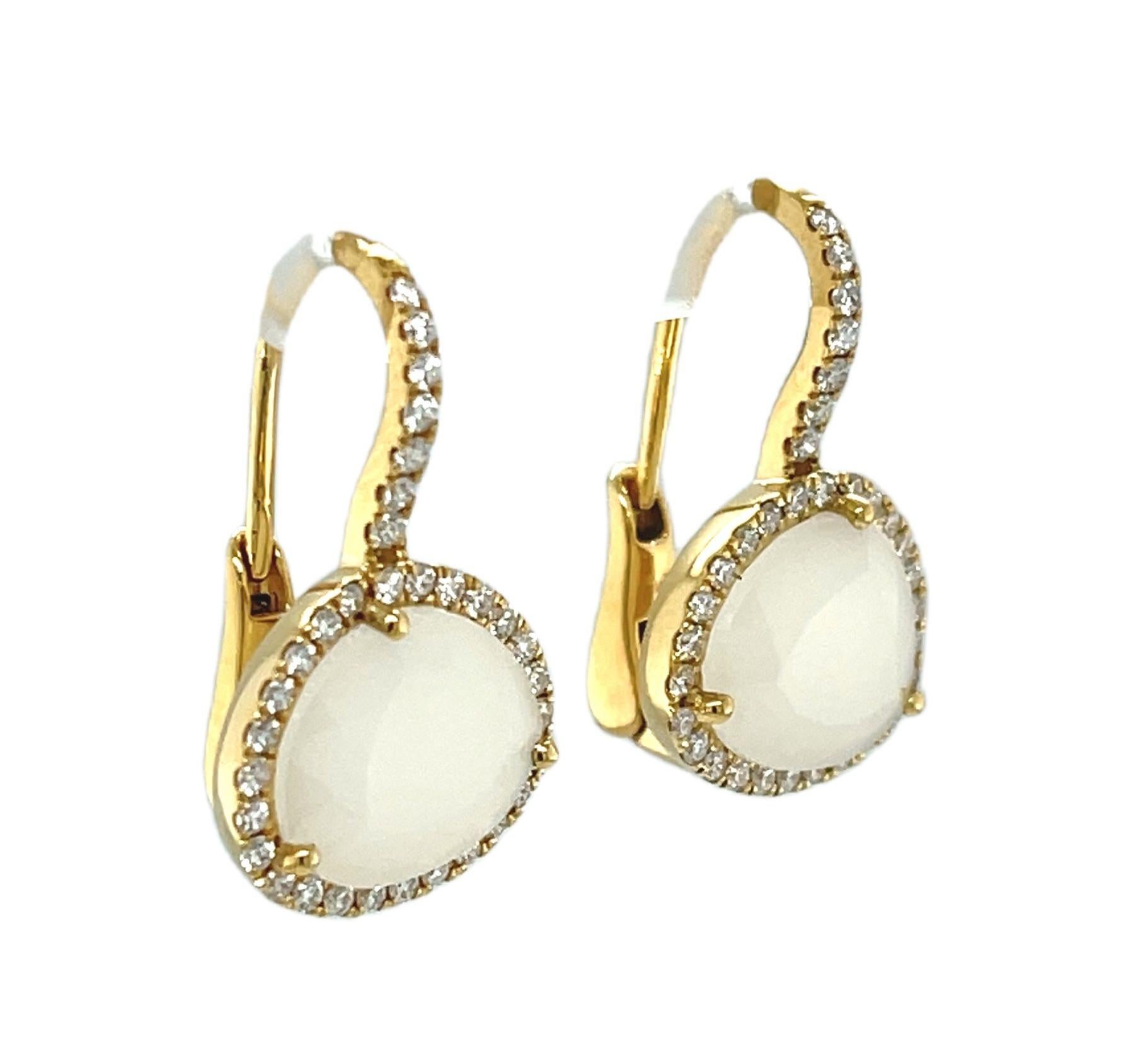These stylish drop earrings feature pearlescent moonstones surrounded by diamond halos crafted in 18k yellow gold. The moonstones have been faceted - a very unique cutting style for moonstone -  allowing them to display beautiful facet reflections