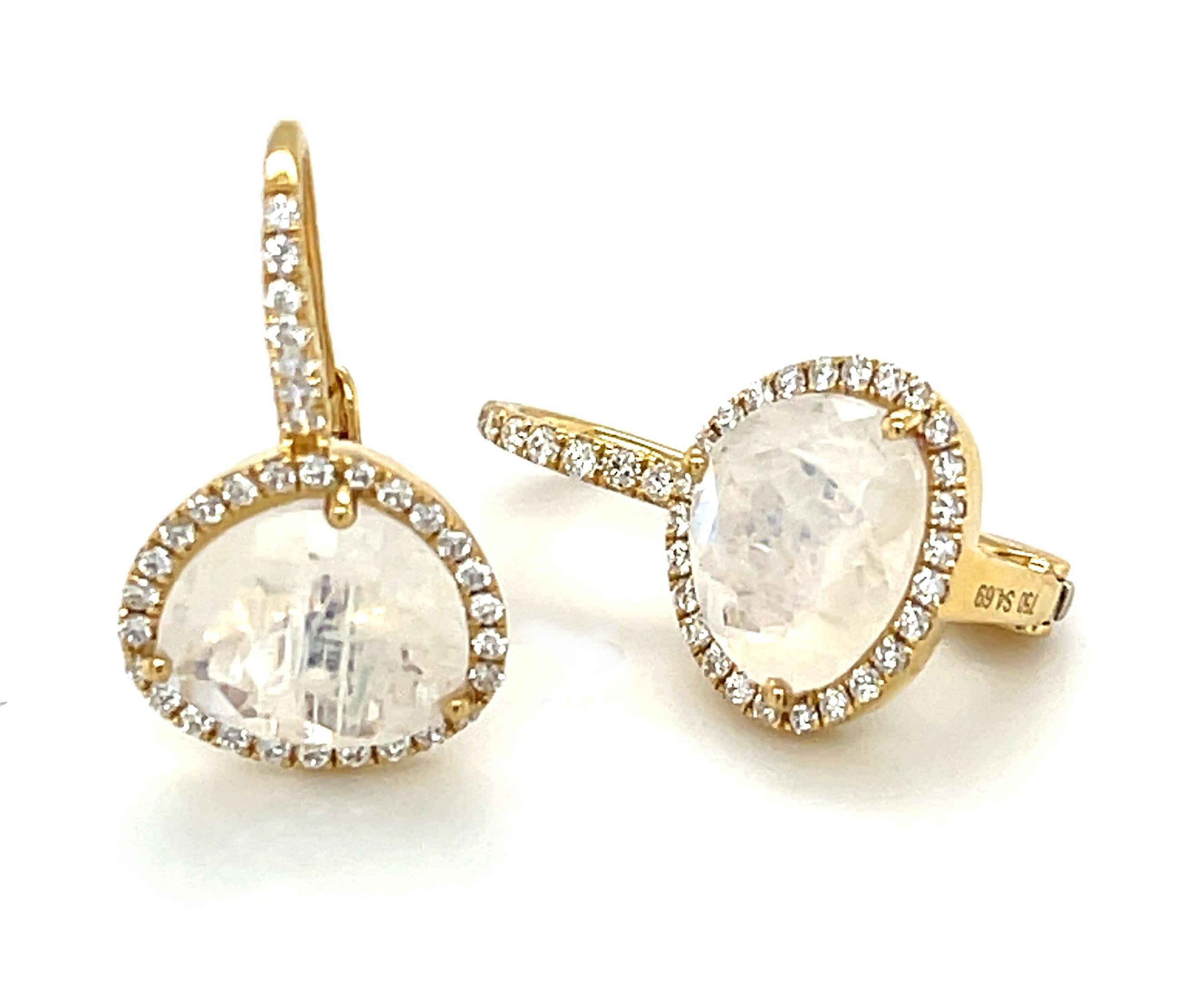 These stylish drop earrings feature pearlescent moonstones surrounded by diamond halos crafted in 18k yellow gold. The moonstones have been faceted - a very unique cutting style for moonstone -  allowing them to display beautiful facet reflections