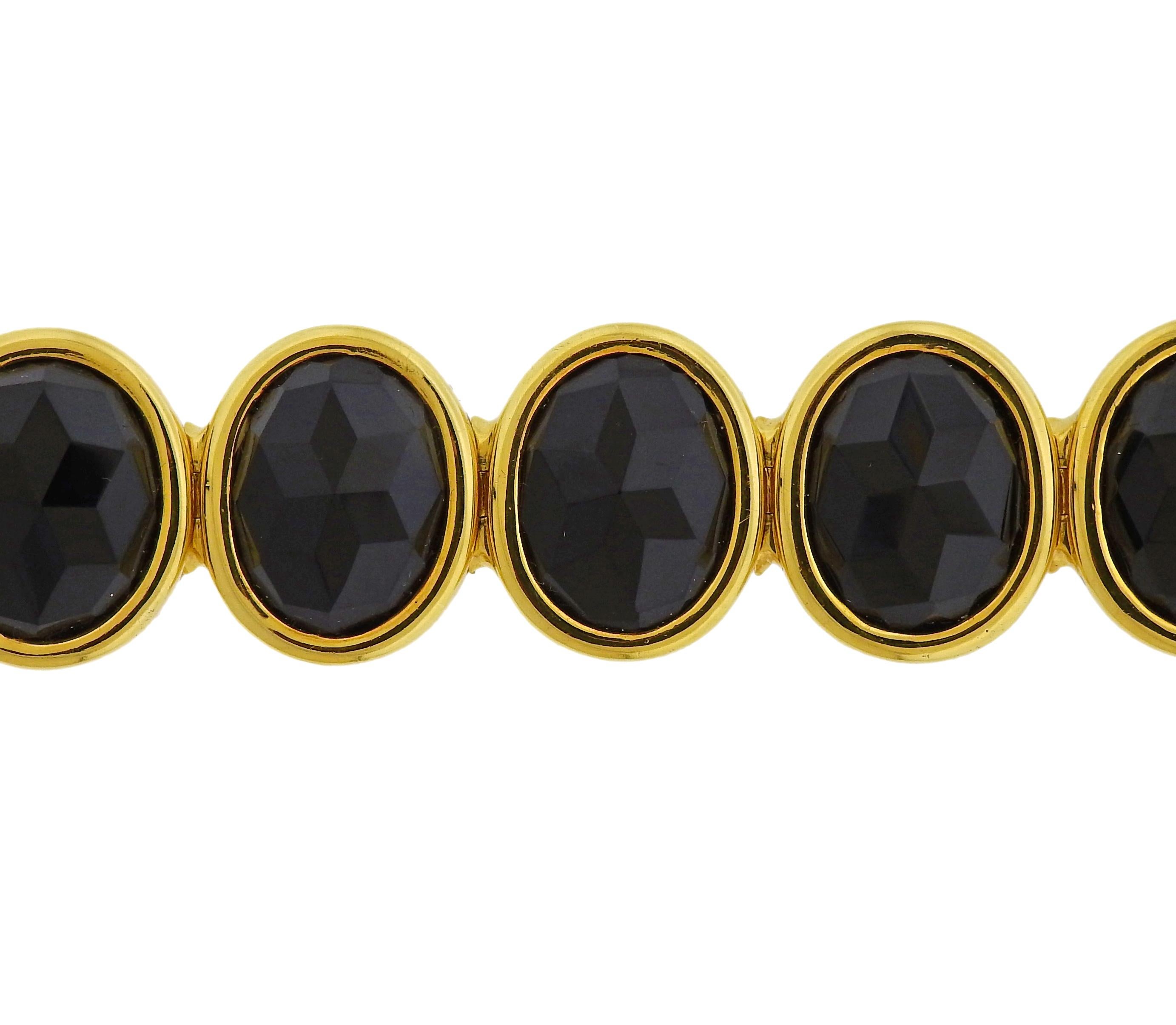 Italian 18k yellow gold oval link bracelet with faceted onyx gemstones. Length of the bracelet is 7
