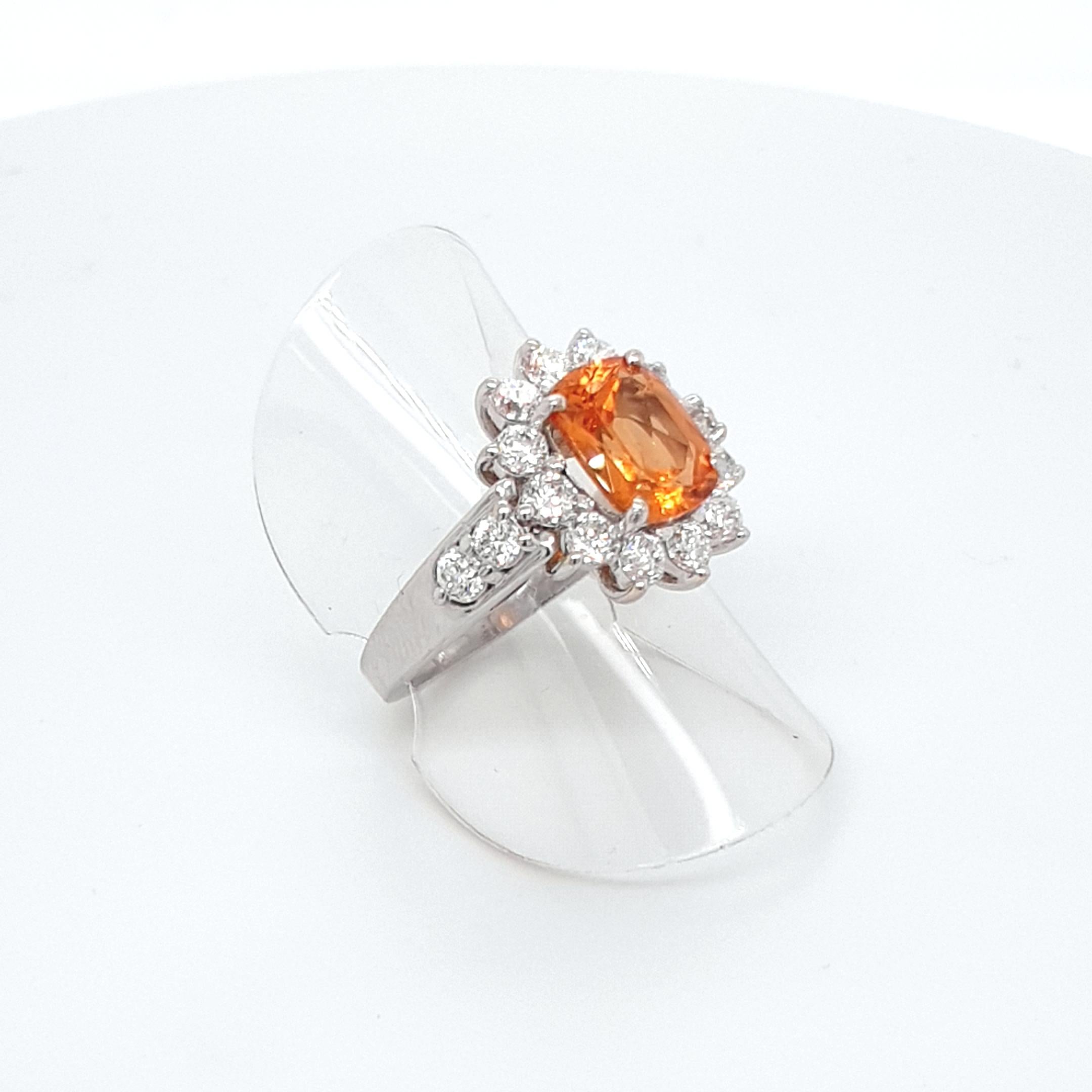 This Natural Faceted Orange Mandarine Garnet Ring with 18 Carat White Gold surrounded by 16 brilliant-cut Diamonds is totally handmade. 
Details:
ringsize: 7 1/2 (55)
Fac. Mandarine Garnet, 3.68 ct.
16 diamonds: 2,10 ct., H / VVS