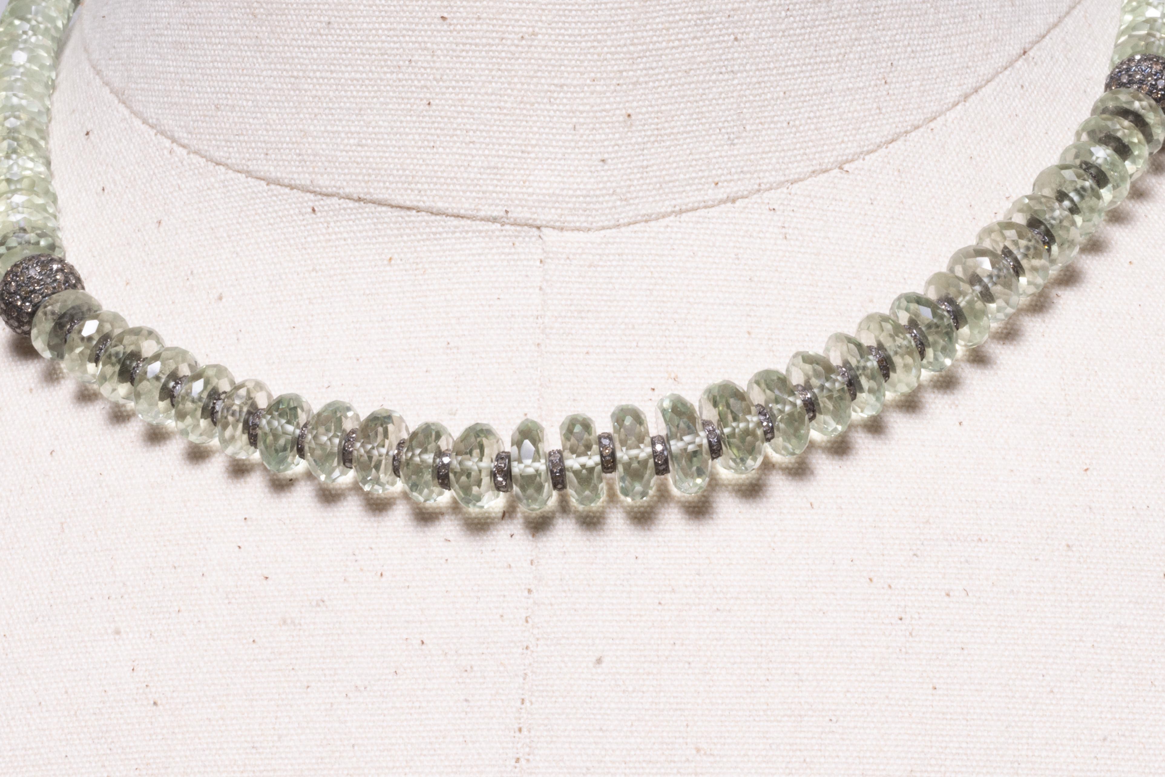 Faceted round prasiolite (green amethyst) beads with diamond rondelles in between and a pave`- set bead at each collarbone set in an oxidized sterling silver, as are the rondelles.  It has extra chain at the back to adjust from 16.5