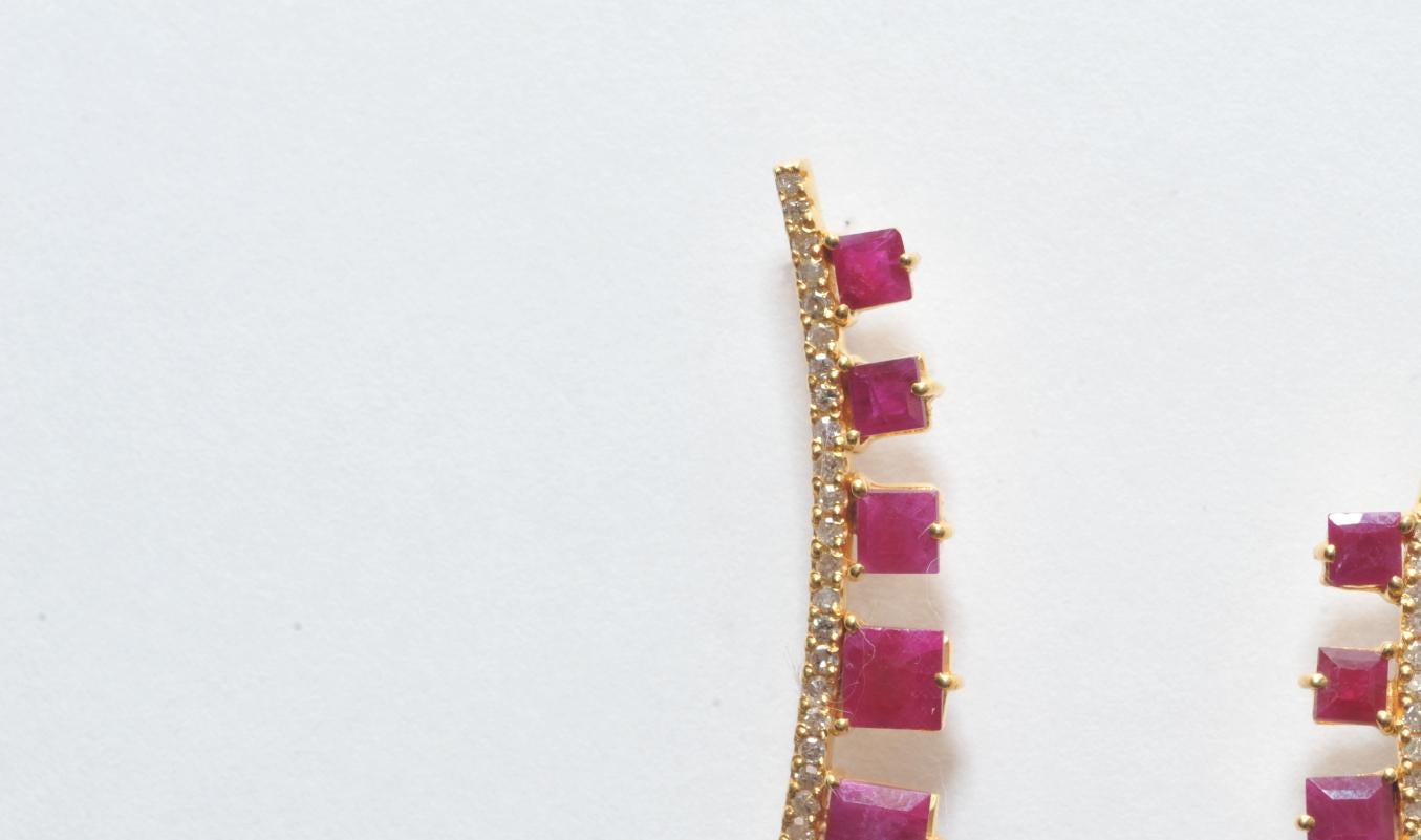 Square-cut faceted and graduated rubies along a diamond spine.  Gold over sterling (vermeil) with 18K gold post for pierced ears.  Diamond weight is .28 carats; Rubies are 2.35 carats.
