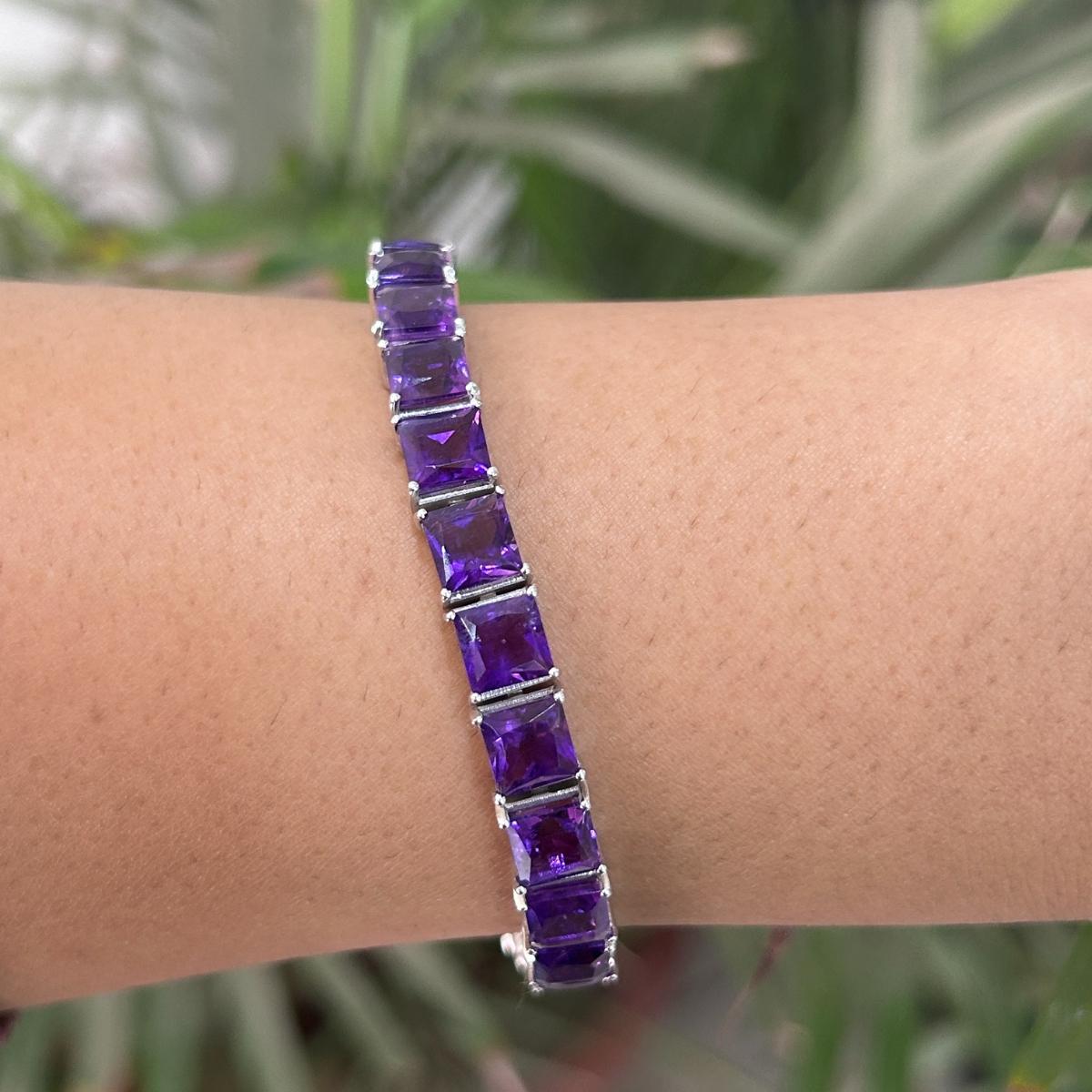 Faceted Square Cut Amethyst Line Bracelet in sterling silver showcases endlessly sparkling natural amethyst, weighing 27.13 carat. It measures 7.25 inches long in length. 
Amethyst stimulate concentration and reduces stress. 
Designed with perfect