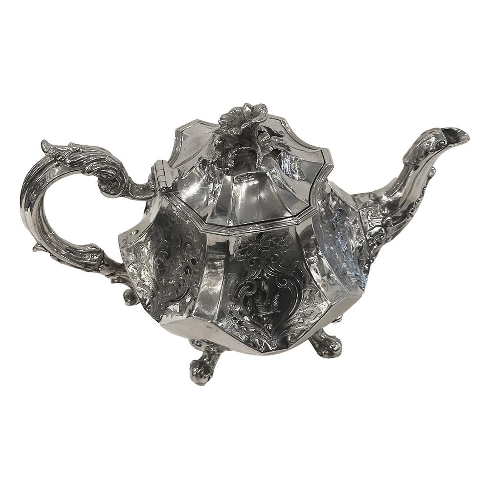 This exceptional 19th-century antique Victorian English sterling silver teapot was crafted by Joseph Angell Sr. & Joseph Angell Jr. in London in 1841. Is a remarkable addition to any silver teaware collection. Its curved facet shape adds to its