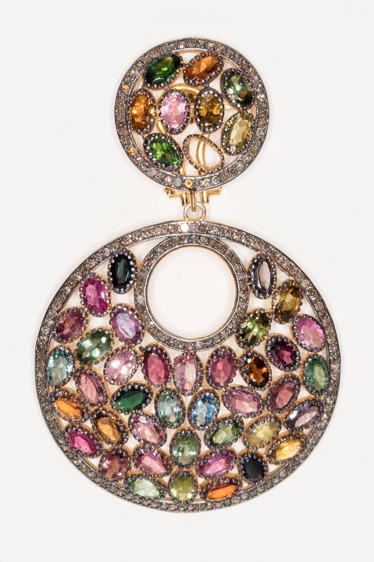 A mosaic of faceted oval tourmalines bordered with pave`set diamonds set in sterling silver with 18K gold post.  All natural stones of great quality in a complete color spectrum of tourmalines.  Diamond weight is 1.95 carats, tourmalines are 24.10