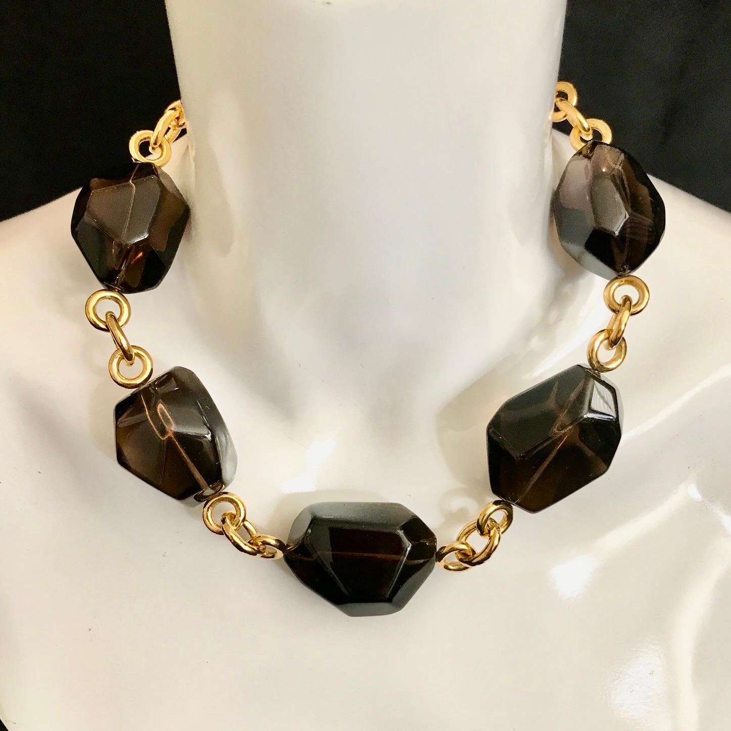 Formed of 5 wonderfully large & lustrous faceted tumbled Smokey Quartz gemstones separated by chunky 'fancy link' connectors & ending in a toggle clasp, this is a bold yet stylishly elegant necklace guaranteed to turn heads. 

The stones measure