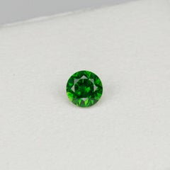 Faceted vivid green Rusisan demantoid garnet with horsetail inclusion, 0.52cts